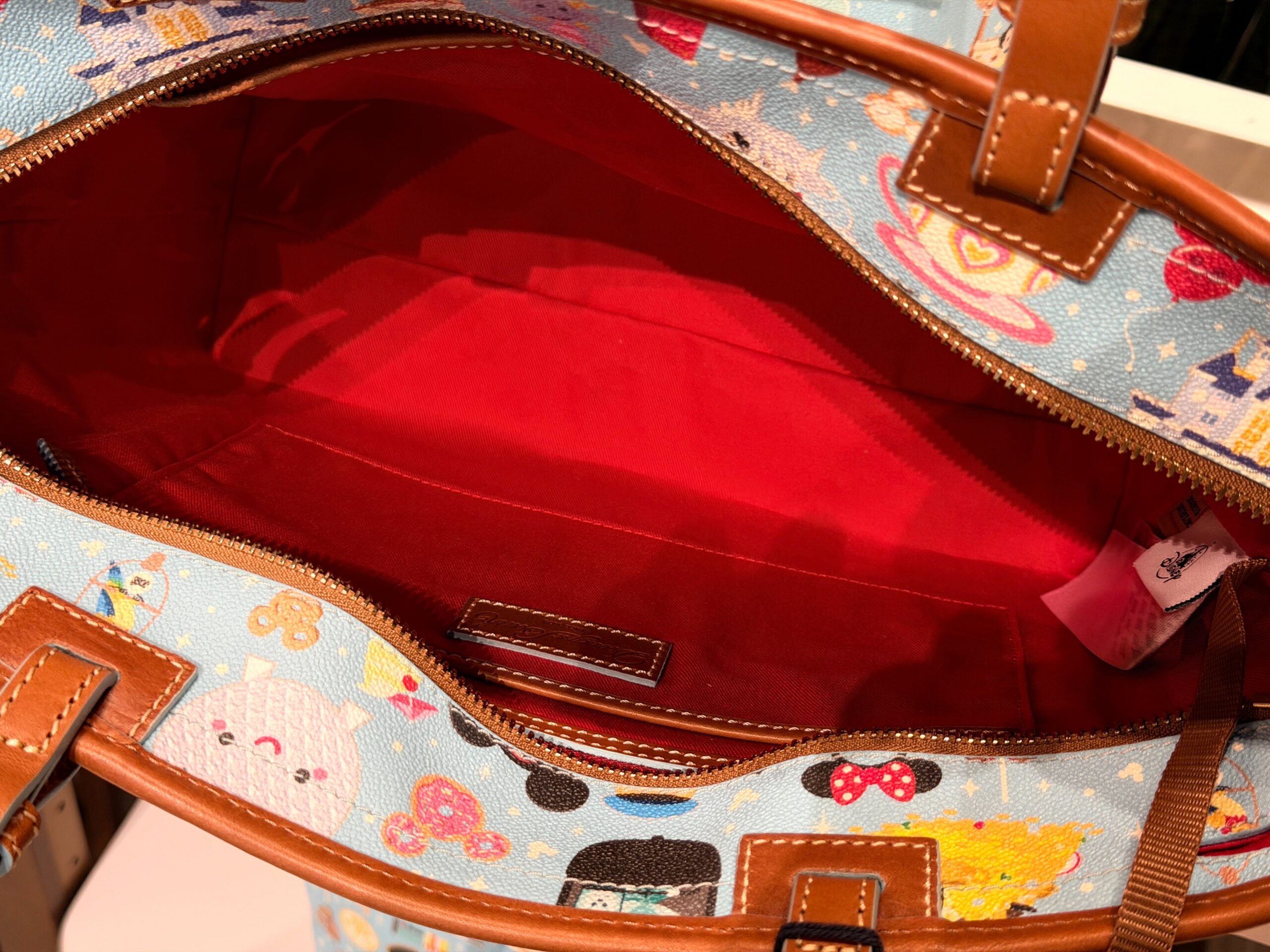 A new Dooney & Bourke bag has arrived with a tiny all-over Disney Parks print that demands a closer look.