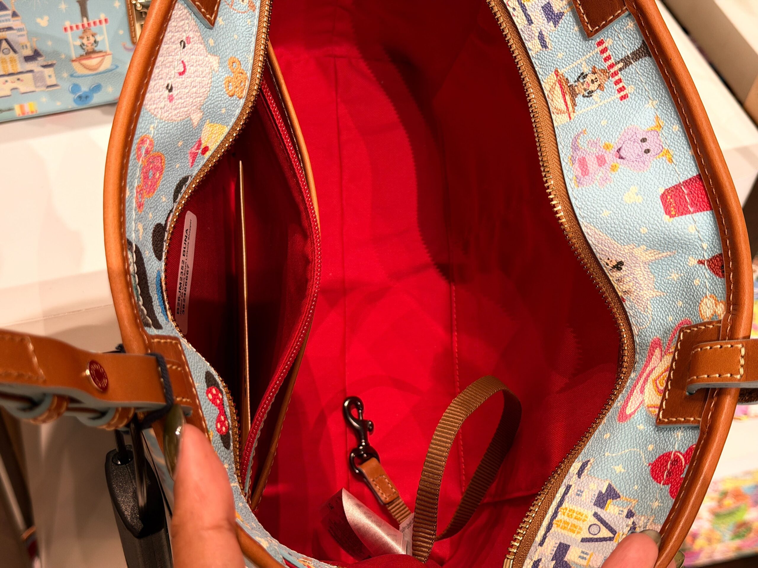 A new Dooney & Bourke bag has arrived with a tiny all-over Disney Parks print that demands a closer look.