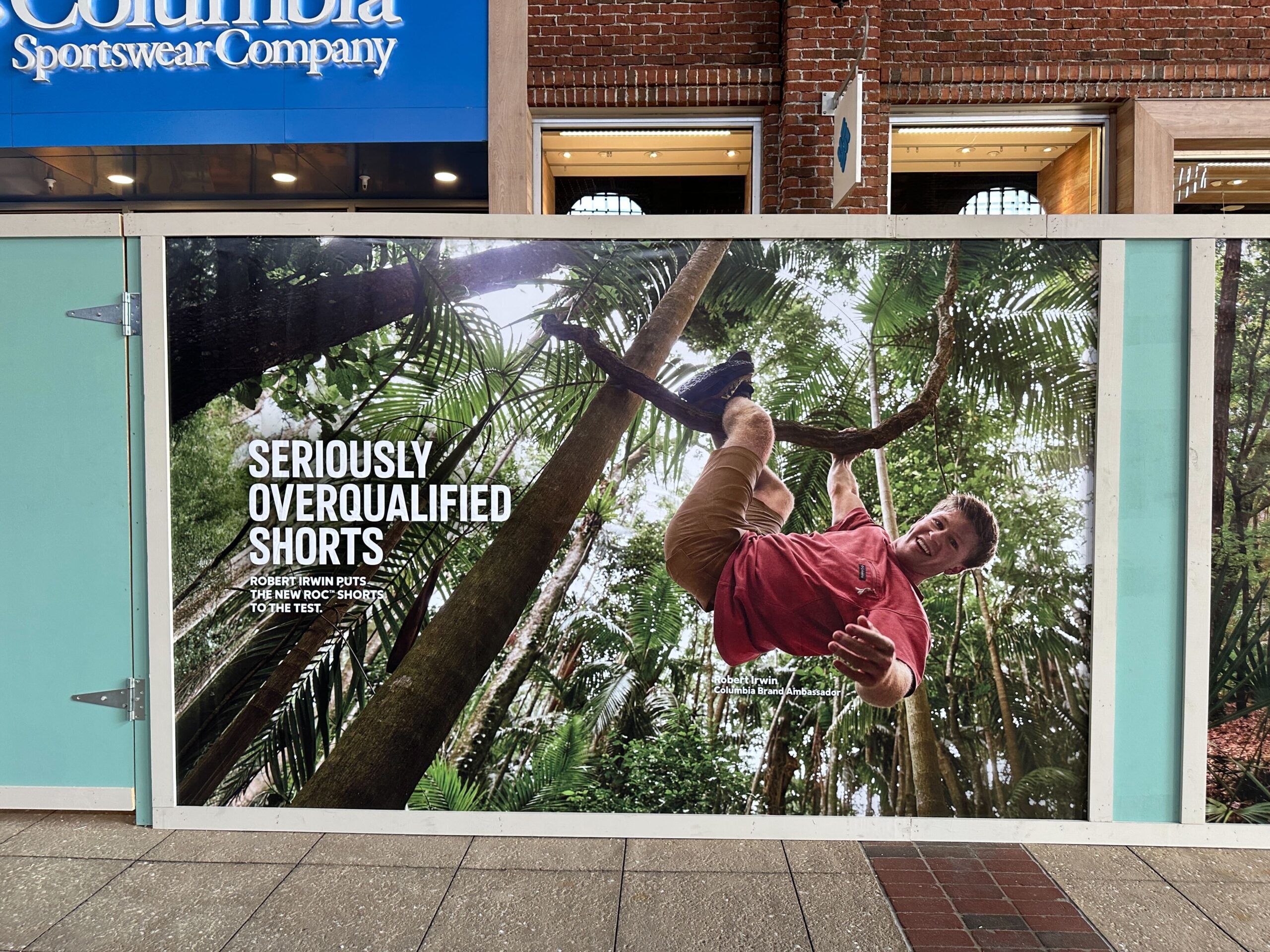 Promotional posters in front of the Columbia Sportswear store at Disney Springs as work begins on refurbishment project.