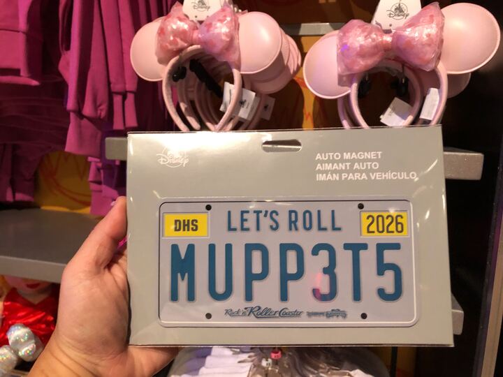 An auto magnet of a license plate has "LET'S ROLL MUPP3TS" in large blue text and the letters "DHS" and 2026 where the registration stickers would go. The Rock 'n' Roller Coaster Starring the Muppets logo is at the bottom.