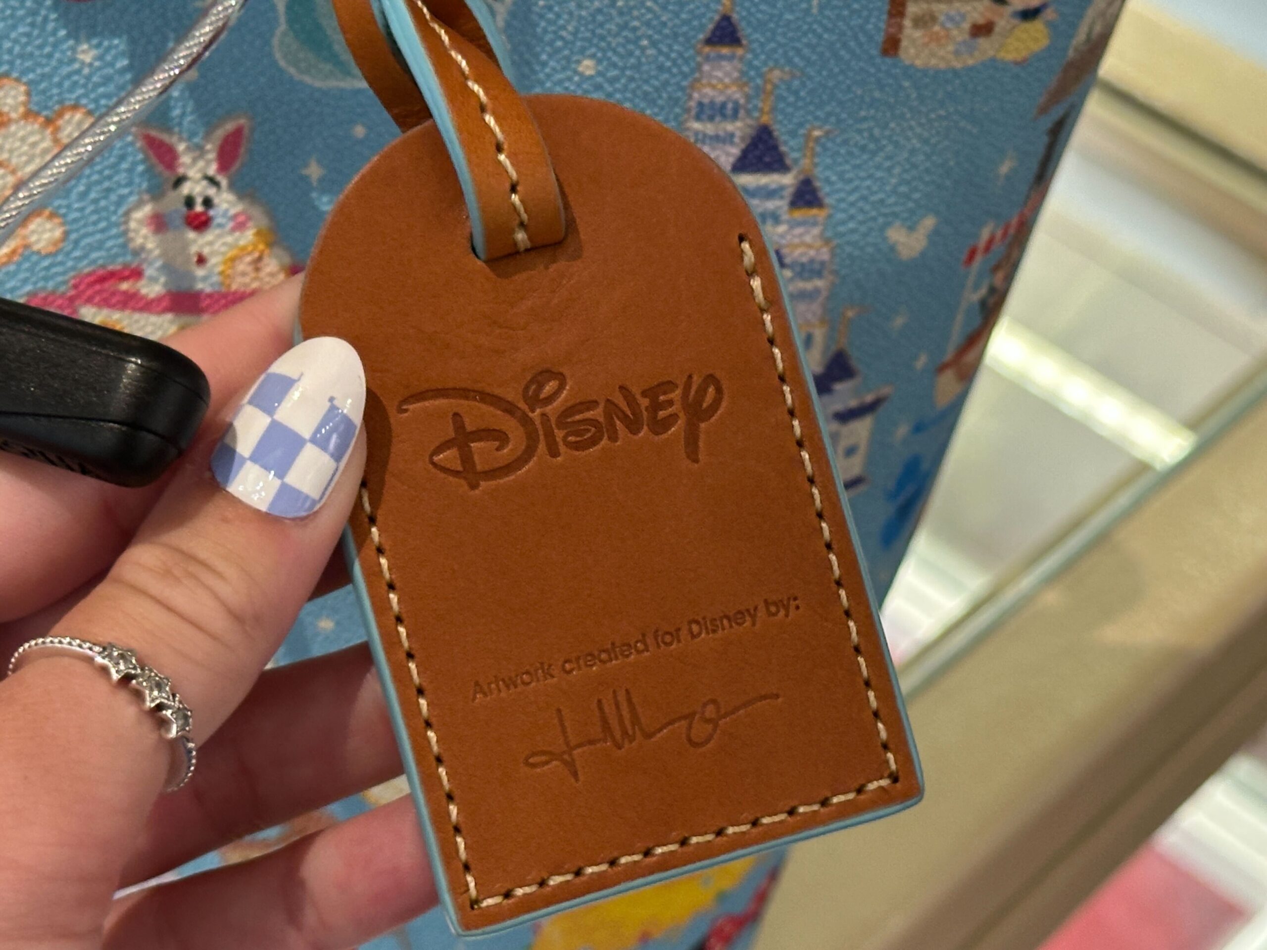 A new Dooney & Bourke bag has arrived with a tiny all-over Disney Parks print that demands a closer look.