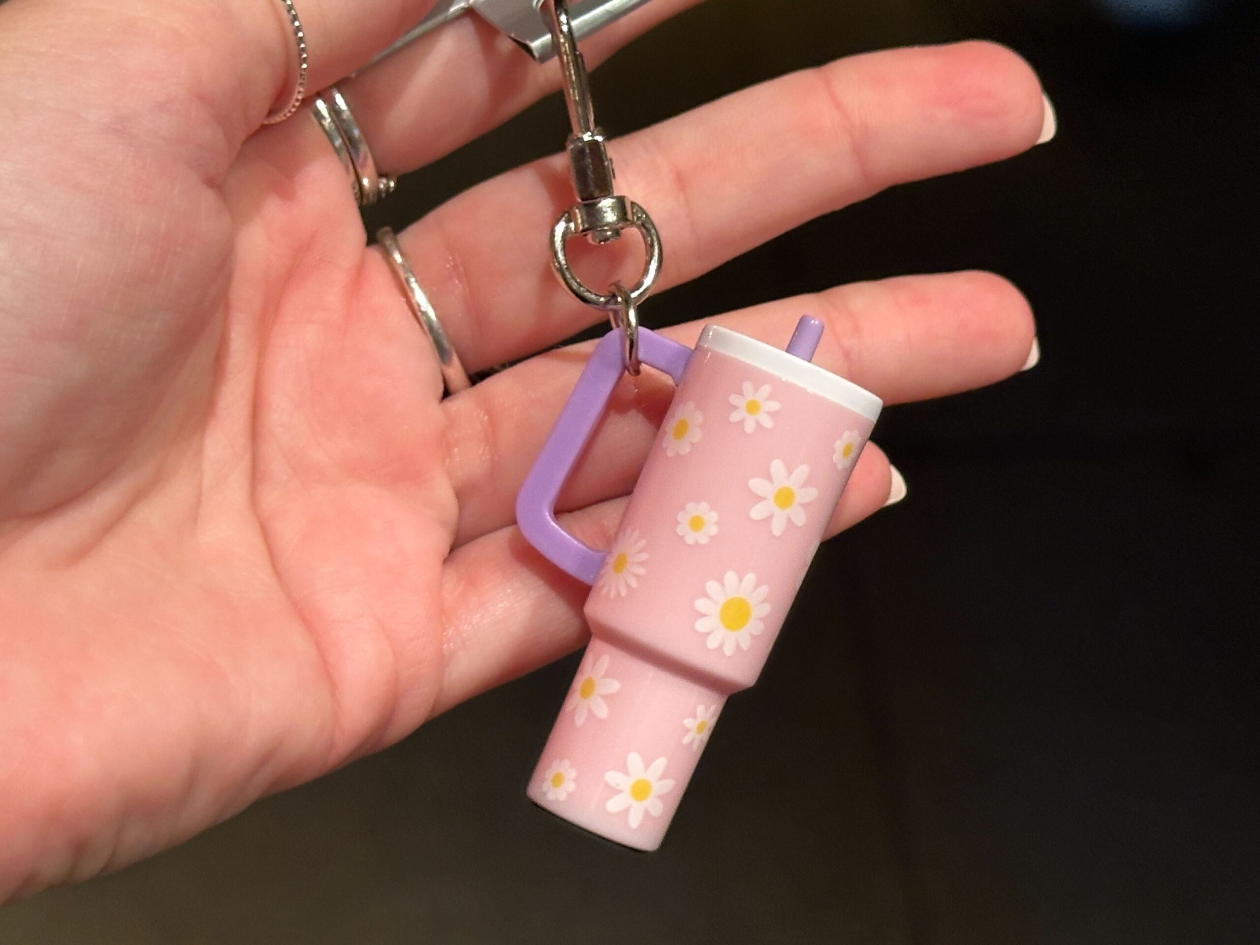 The small charms are designed to resemble the explosively popular 40oz tumblers from recent years. They hang from silver-tone key rings and lobster clasps, making them easy to attach to a bag, backpack, lanyard, or set of keys.