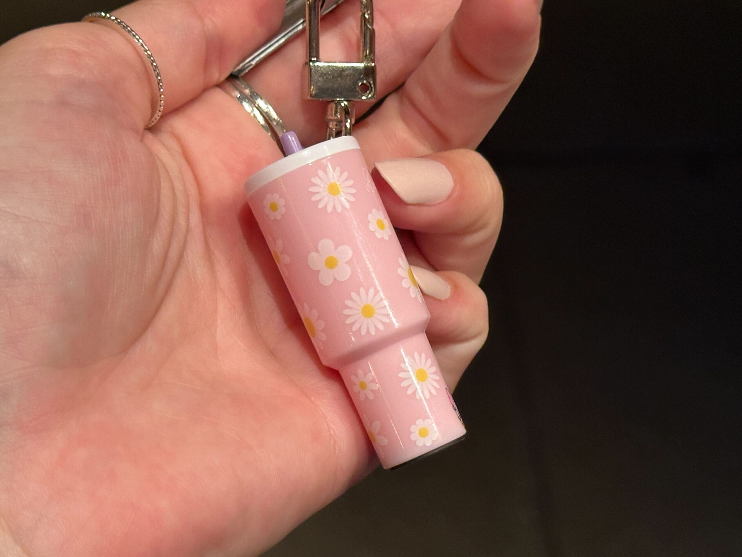 The small charms are designed to resemble the explosively popular 40oz tumblers from recent years. They hang from silver-tone key rings and lobster clasps, making them easy to attach to a bag, backpack, lanyard, or set of keys.