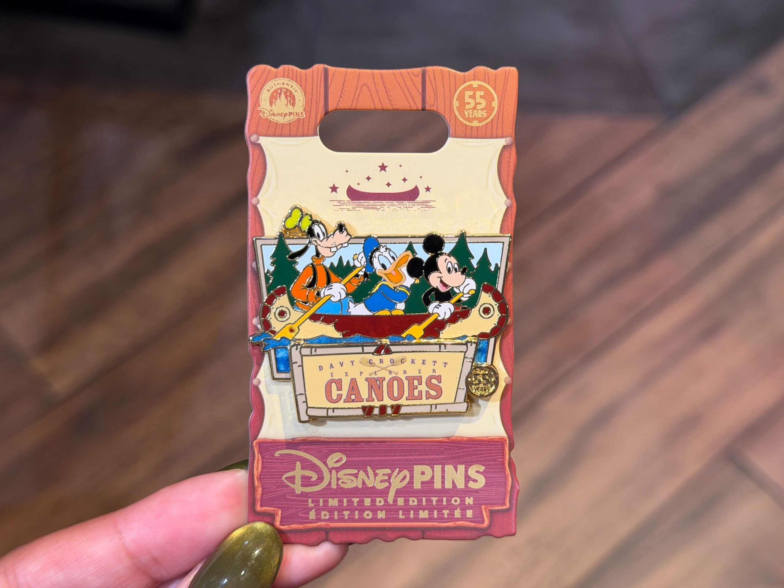 Celebrating the 55th anniversary of the Davy Crockett Explorer Canoes at Disneyland, this pin shows Mickey, Donald, and Goofy enjoying a ride. It has a small, gold "55 years" medallion to the right of the attraction name.
