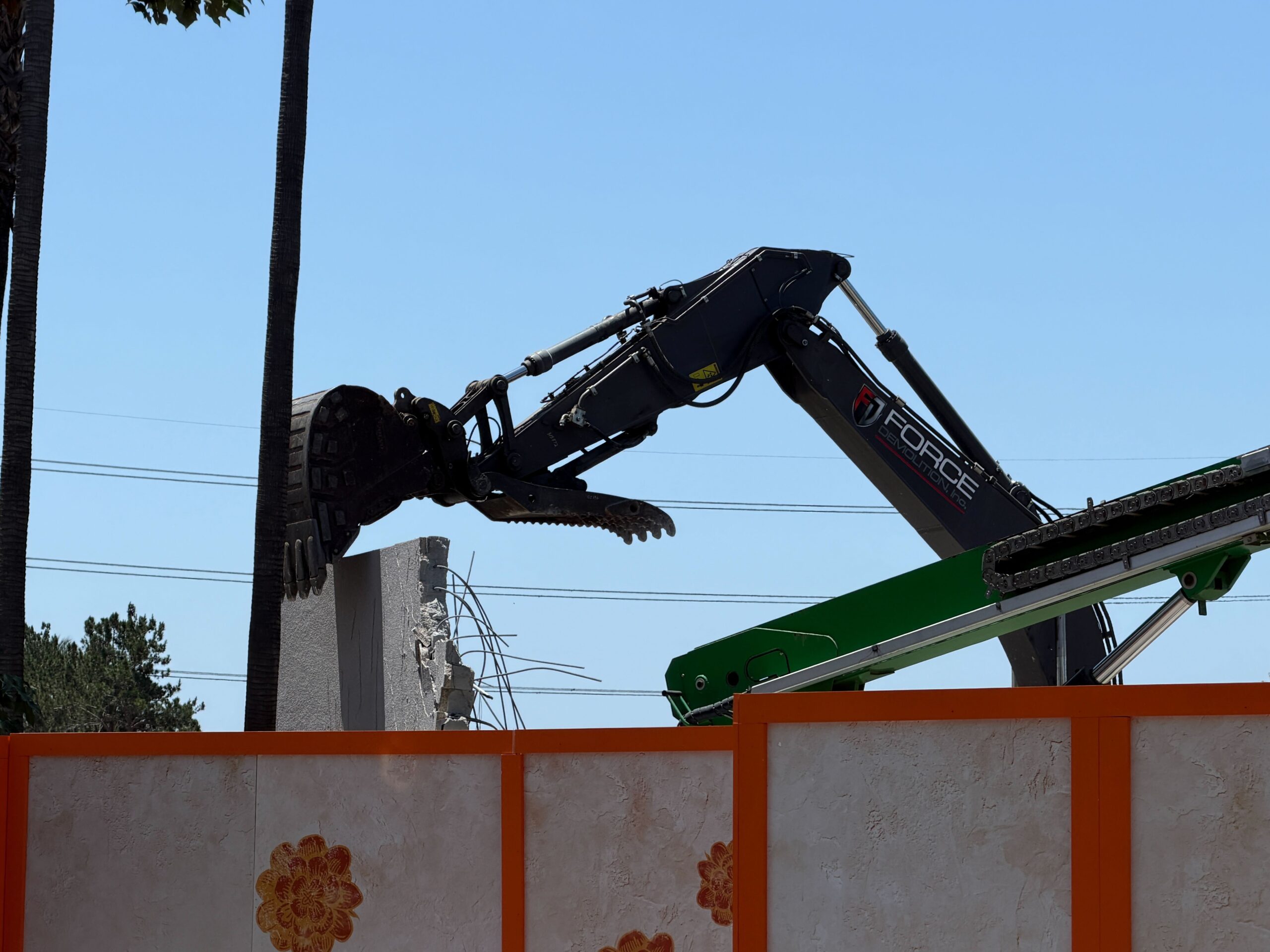 In another spot visible from the walkway, we could see an excavator poised to bring down a concrete wall.