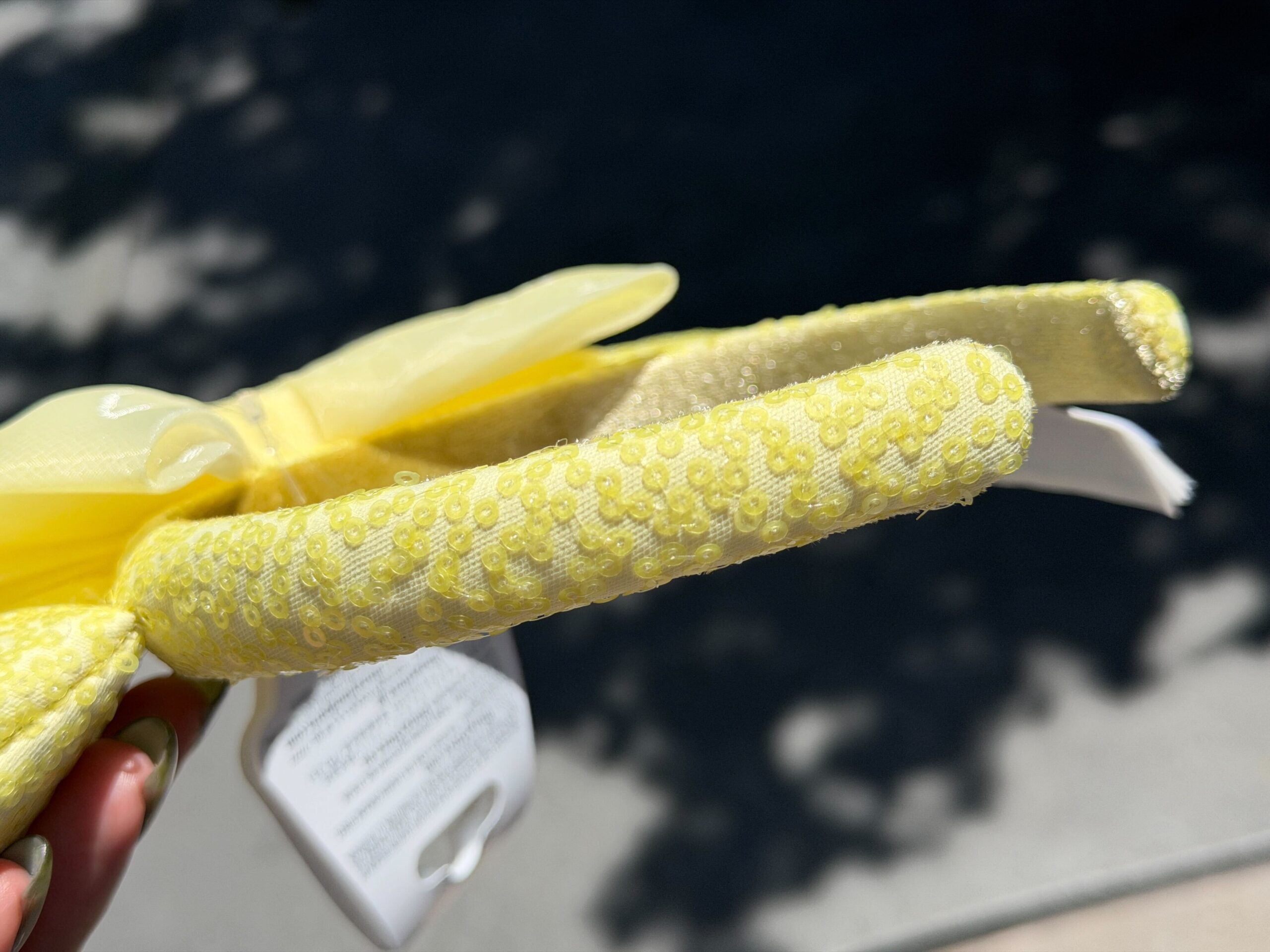 The ear headband is a similar butter yellow color with sequins covering the ears and headband.