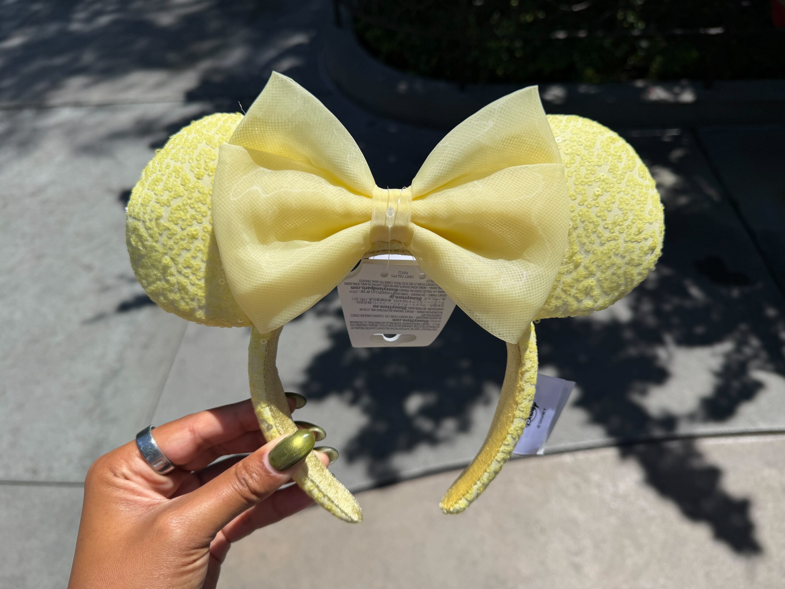 The ear headband is a similar butter yellow color with sequins covering the ears and headband.