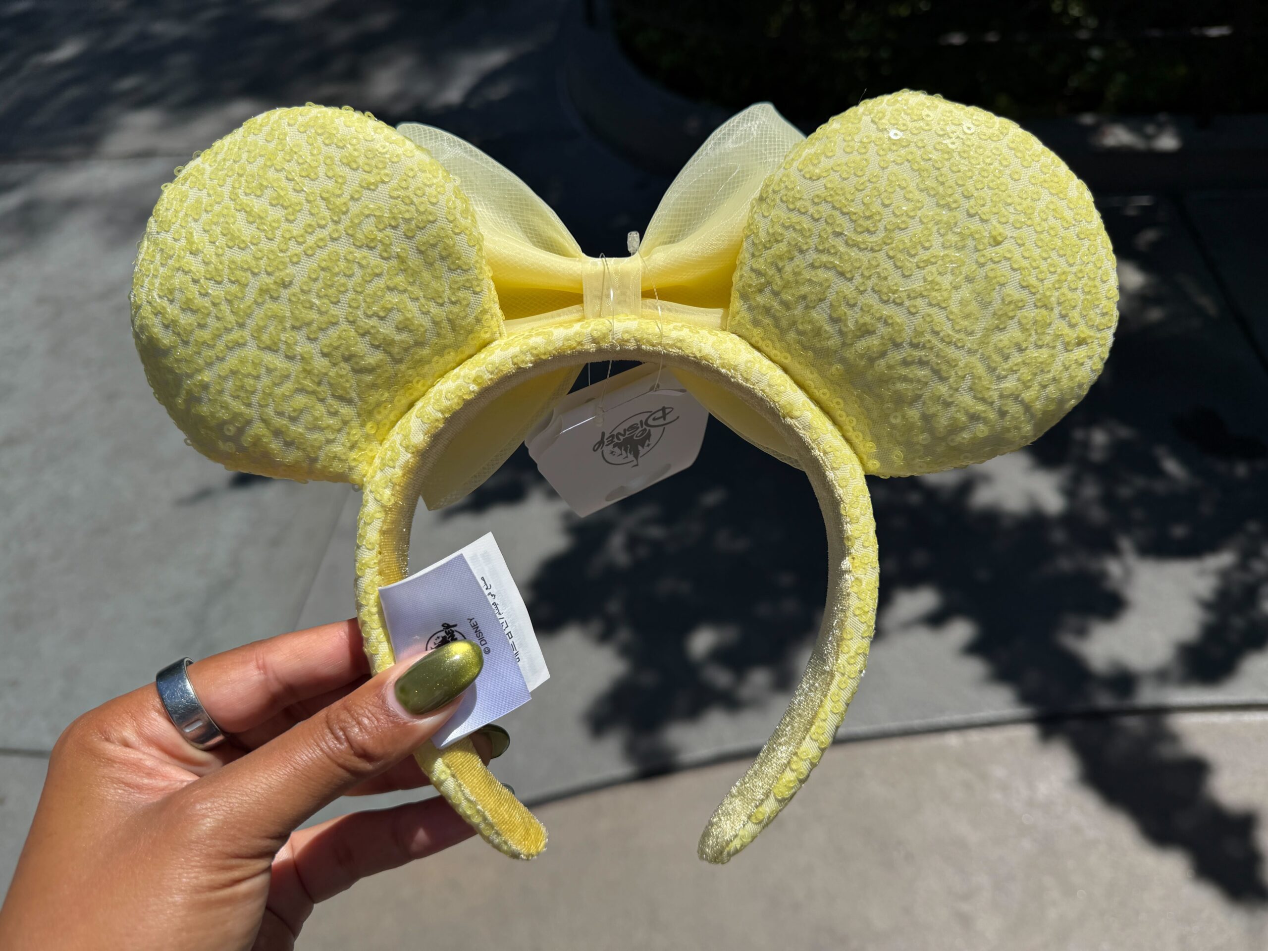 The ear headband is a similar butter yellow color with sequins covering the ears and headband.