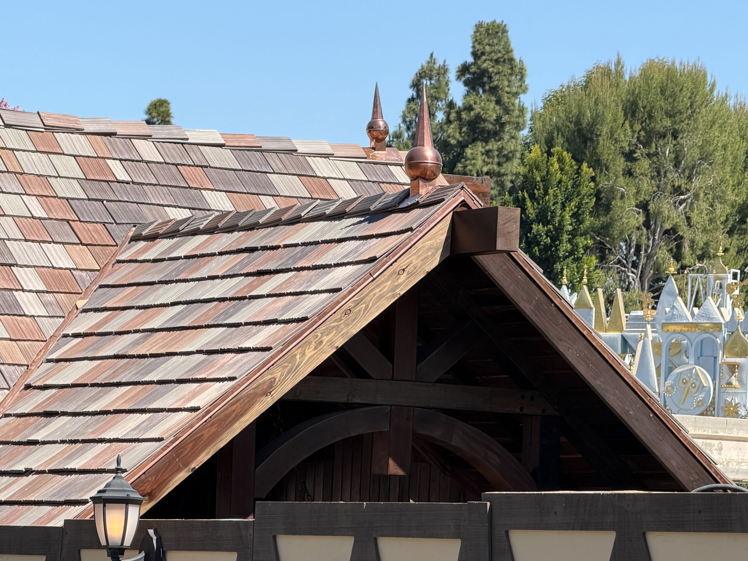 The structure's multicolored brown shingle roof has now been complete, matching the exterior of Edelweiss Snacks. Several new bronze spires have also been added to the edges of the roof peaks.