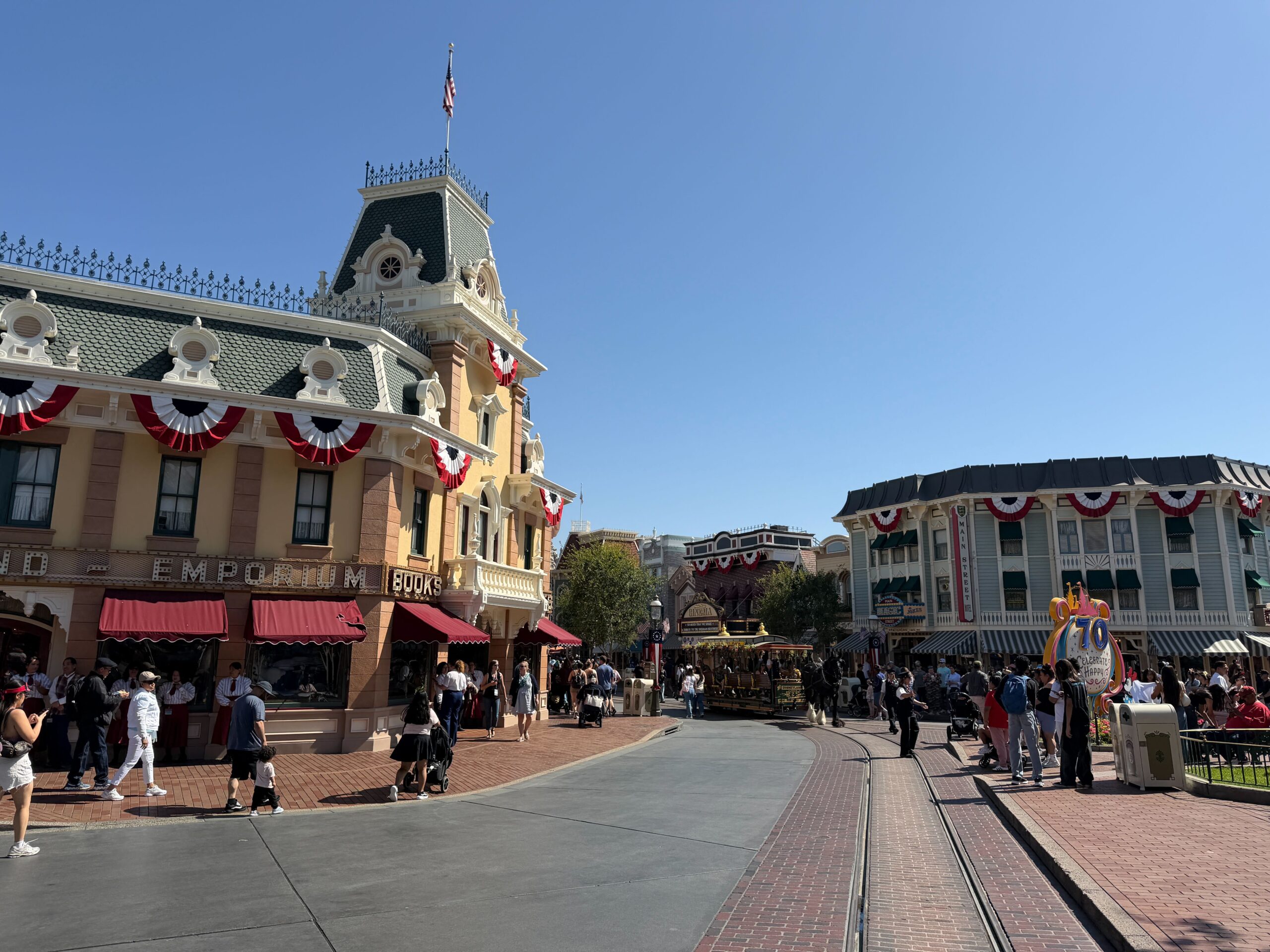 City Hall, the Emporium, and more facades are adorned with red, white, and blue bunting. They hang from roofs and balconies.