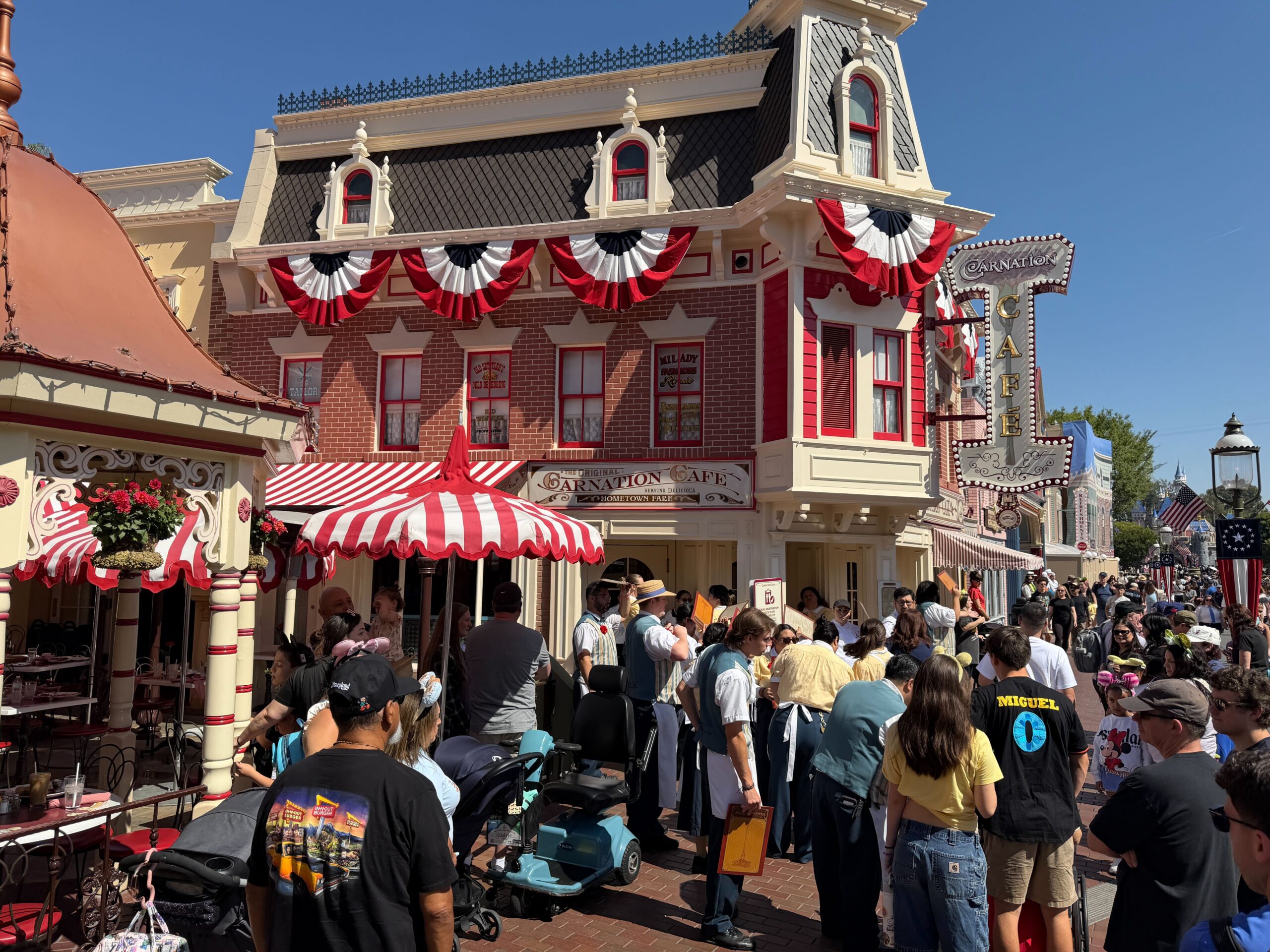 City Hall, the Emporium, and more facades are adorned with red, white, and blue bunting. They hang from roofs and balconies.