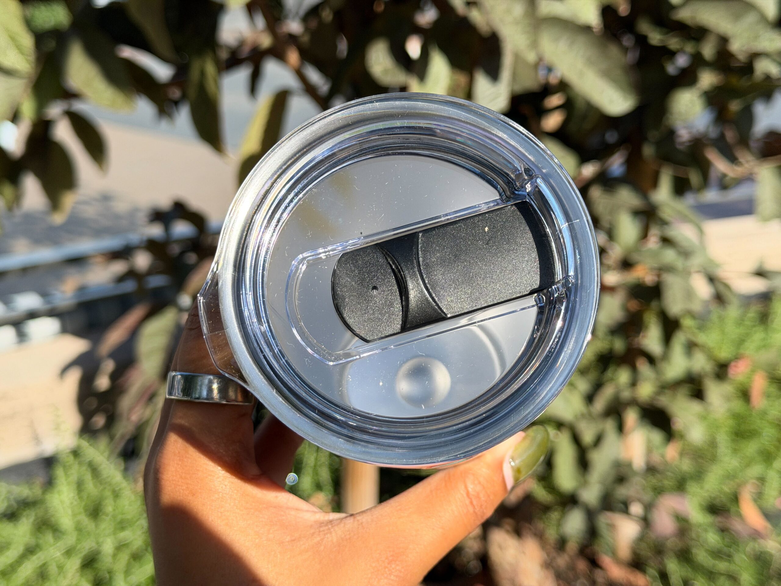 The lid of the tumbler has a sliding plastic sipper cover.