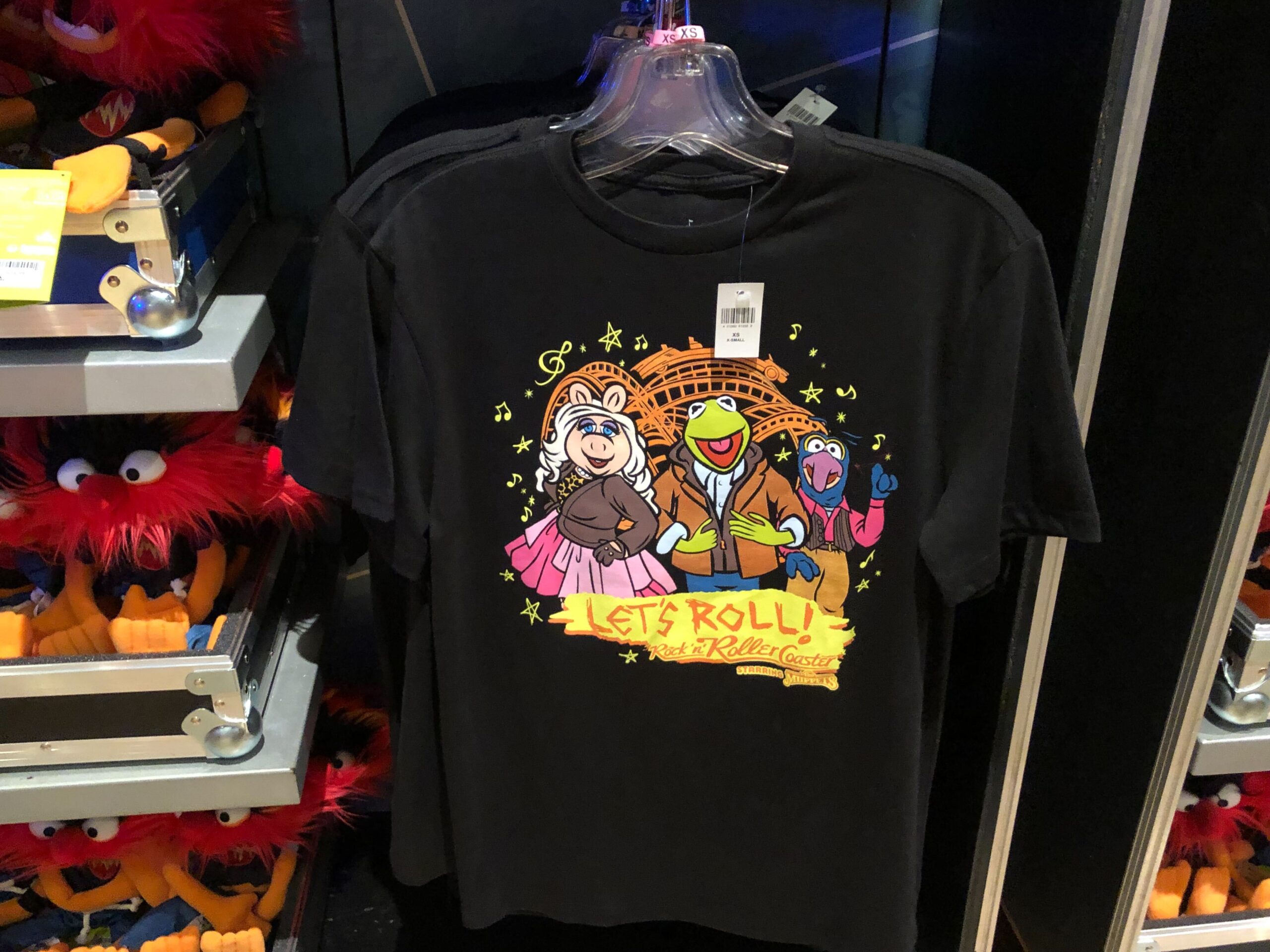 Miss Piggy, Kermit, and Gonzo appear on this black shirt with "Let's Roll!" and the Rock 'n' Roller Coaster Starring the Muppets logo.