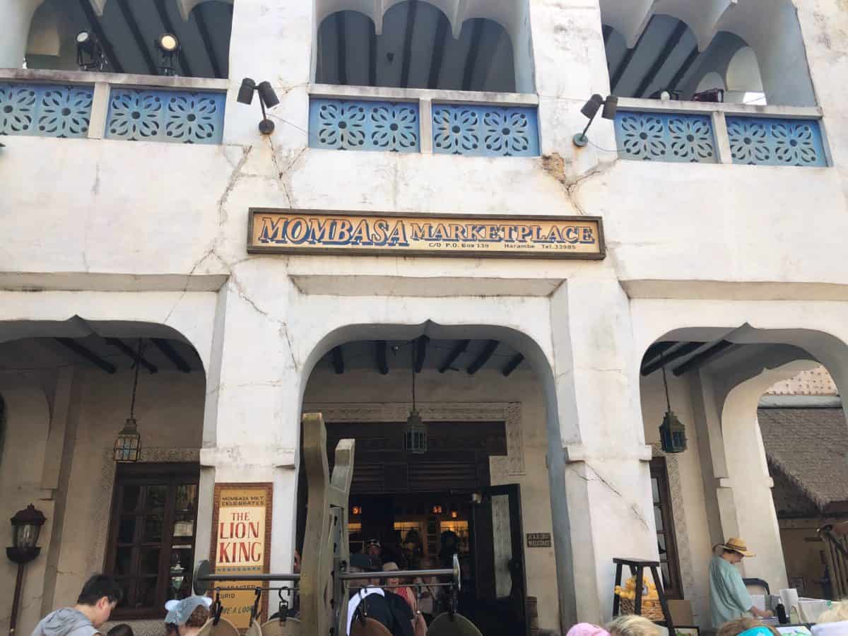 Mombasa Marketplace shop at Disney's Animal Kingdom. The facade is made with white stone and blue balcony railings.