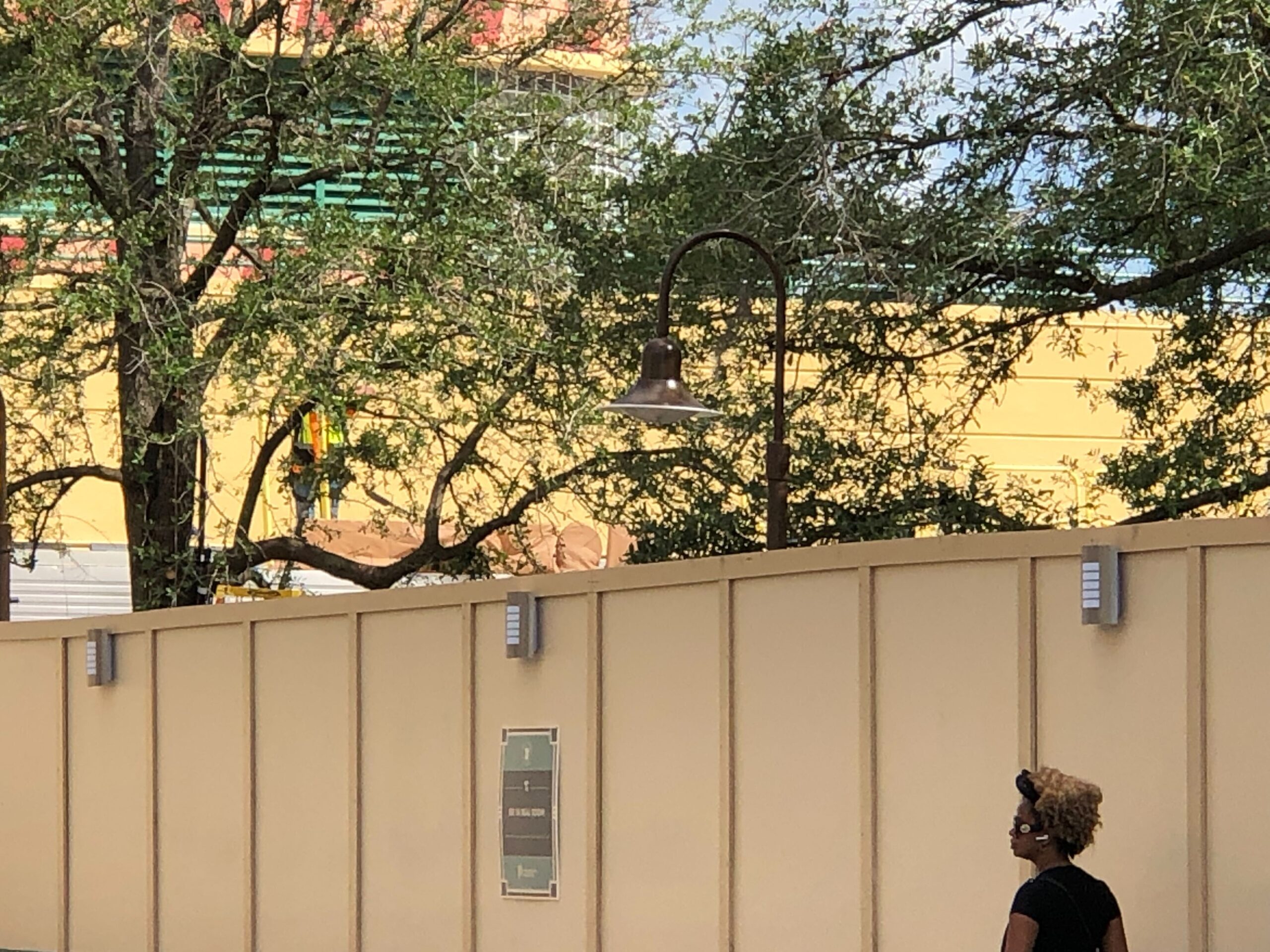 To the right of the marquee is a sign covered by pieces of scrim. We saw this in aerial photos earlier this month, but some of the scrim has been adjusted, making it easier to see the sign consists of large letters — just like the courtyard's other new signage.