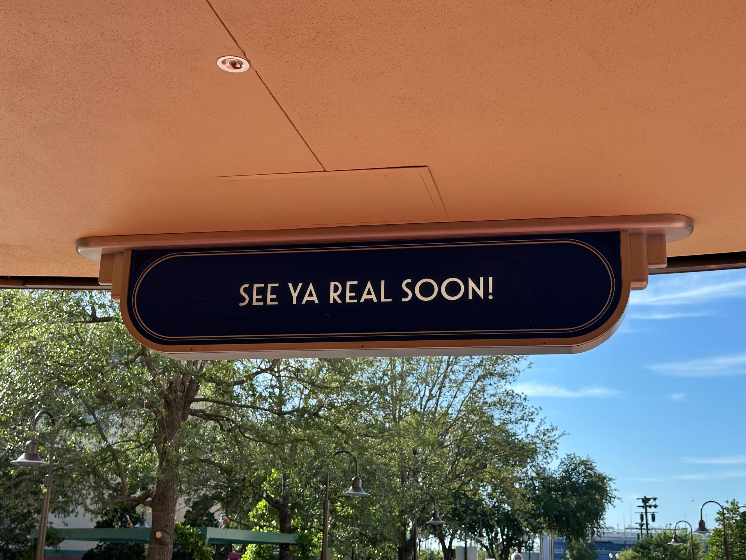 Because The Magic of Disney Animation is not open yet, there are still some walls in the area. As guests exit the area, a sign says "See Ya Real Soon!"