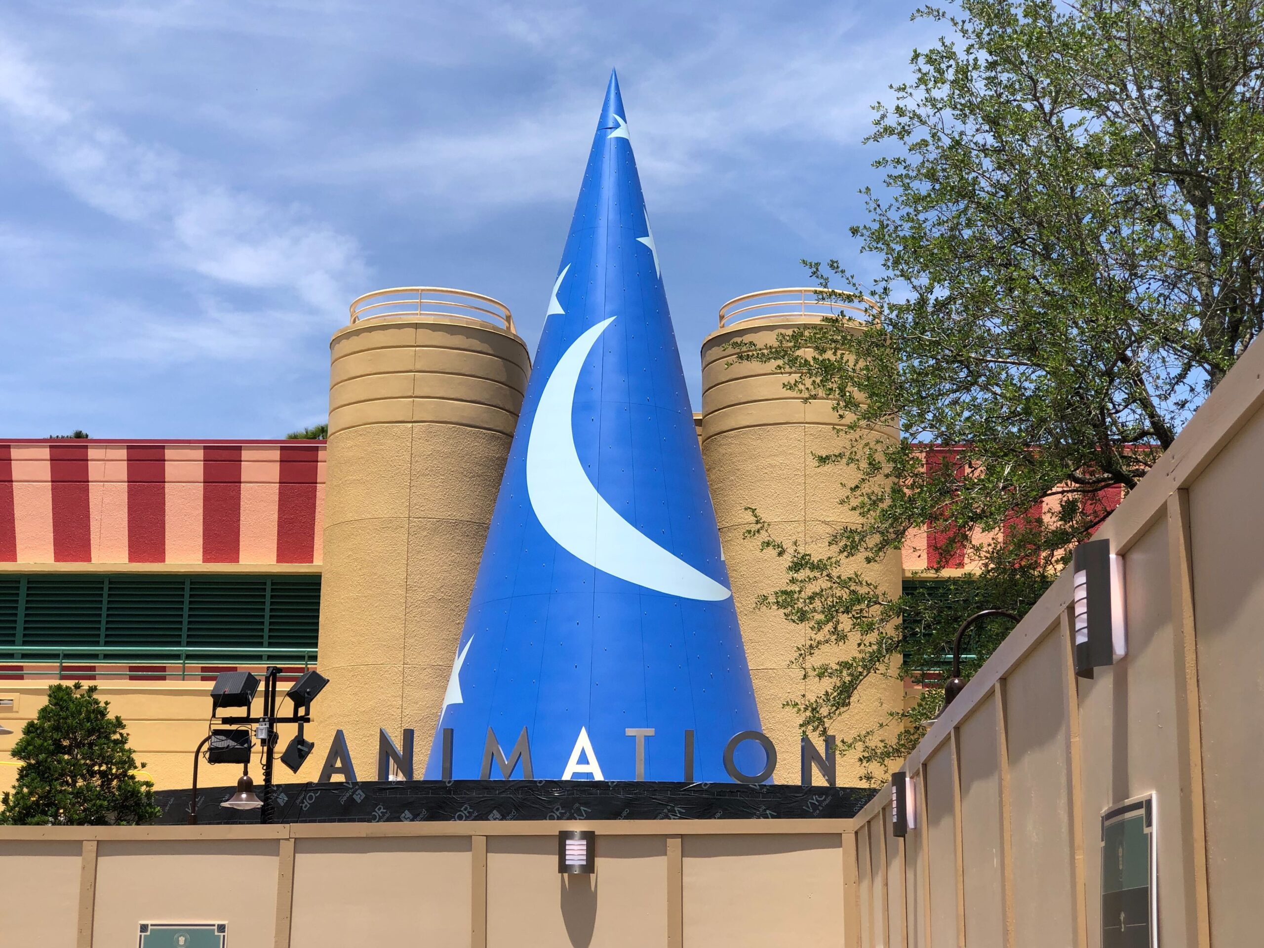 The big silver letters sit below the giant sorcerer hat on the front of the building. Guests will enter The Magic of Disney Animation under the letters.