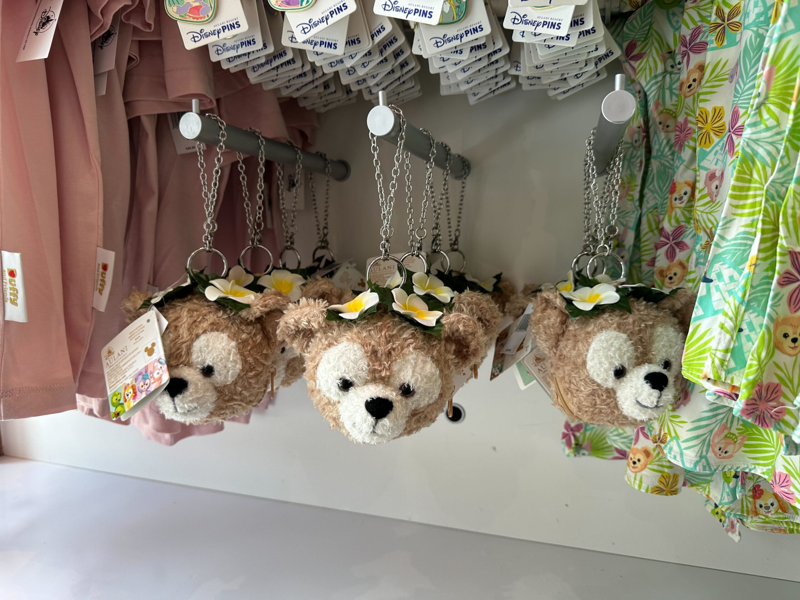 The packable tote comes inside a plush Duffy head. It has a ring attached to a chain that can be clipped to a larger bag or worn as a wristlet.