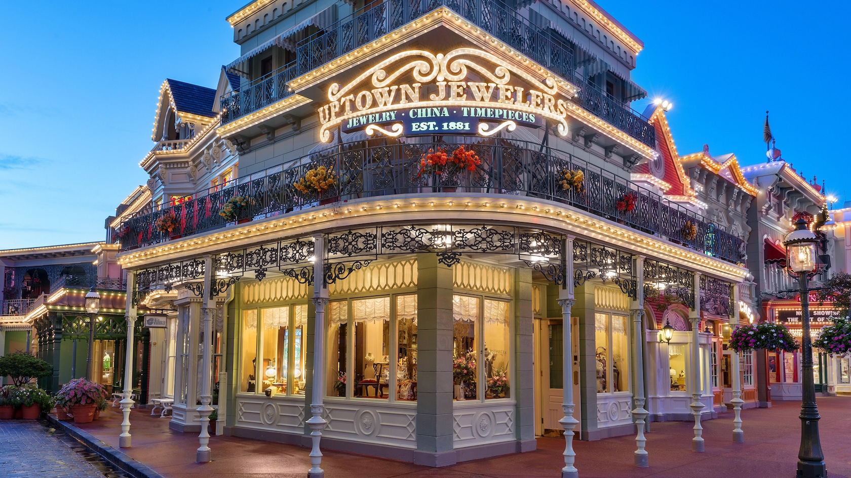 Uptown Jewelers shop on Main Street, U.S.A. in Magic Kingdom at Walt Disney World. The building is covered in wrought iron fences and yellow lights.