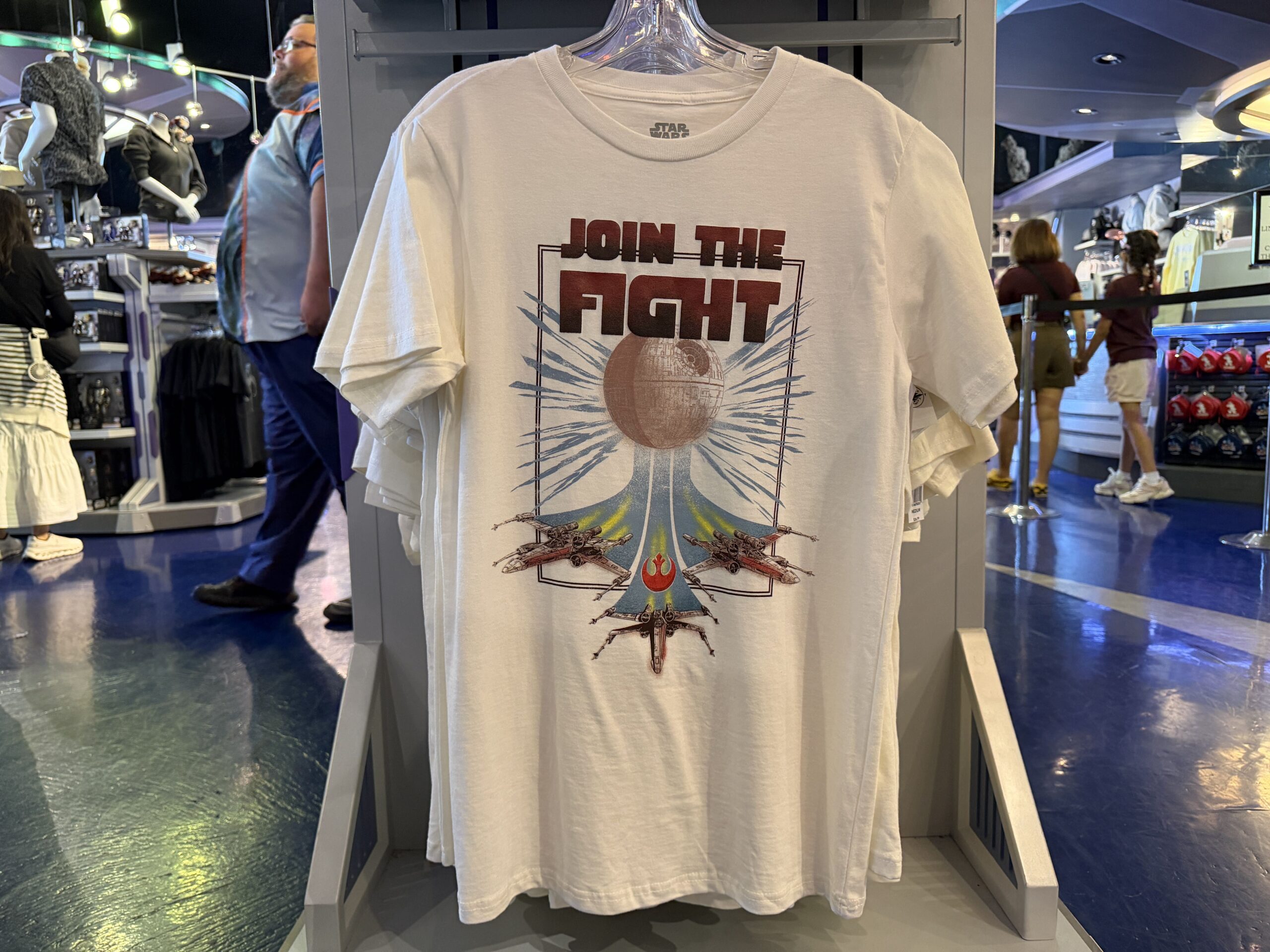 A new wave of Star Wars merchandise has arrived at Disneyland, including several graphic T-shirts, a keychain, and multiple Hasbro Black Series figures inspired by Star Wars: Attack of the Clones, The Mandalorian & Grogu, Star Tours, and more.