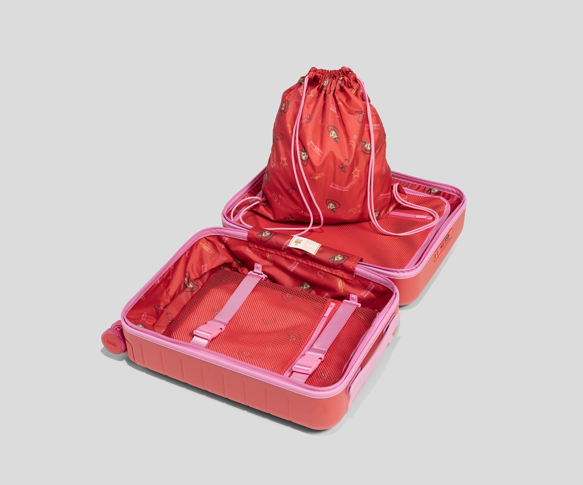 The Jessie-inspired kids suitcase is red with graphics of Jessie, a brown cowboy boot, her name, and her sheriff badge.