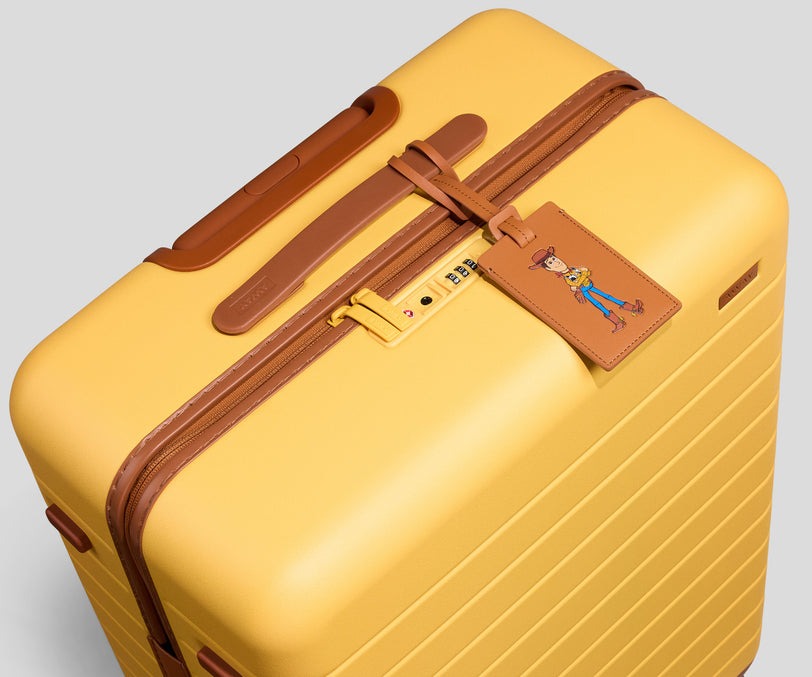 The Medium is Away's midsize luggage with a capacity of 72 L. The exterior measures 26" x 18.5" x 11". The Woody Yellow version has a matte finish with brown trims.