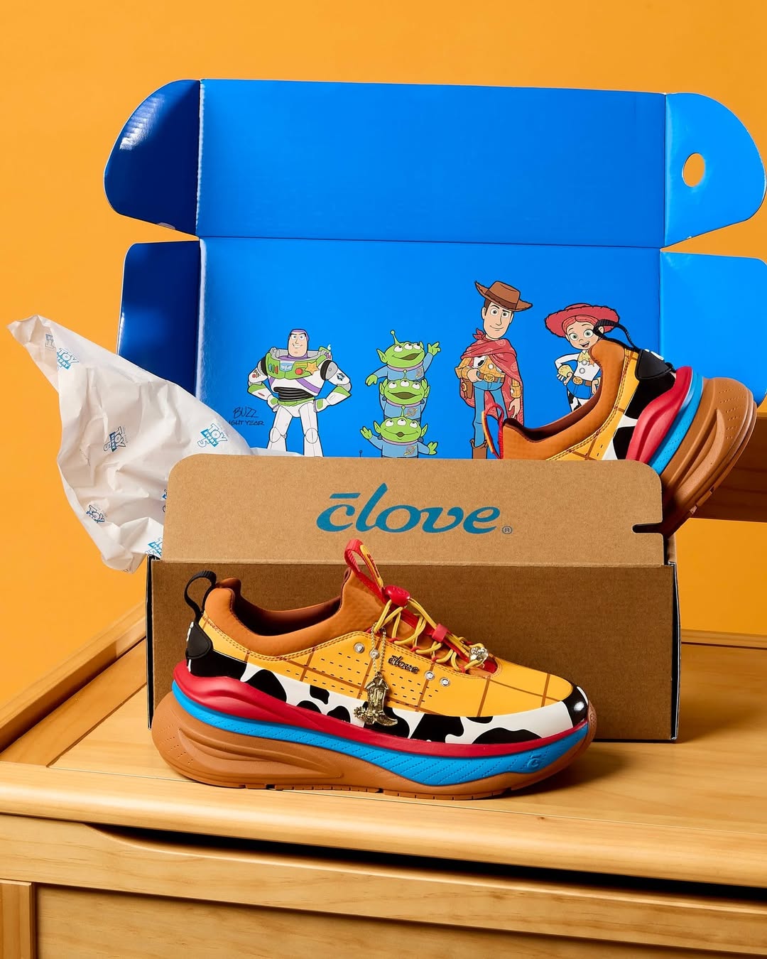 The Woody shoe's styling is based on the toy's famous costume. The top part is yellow with red windowpane lines and matching laces. That's followed by stripes of black and white cow print, red, and blue with a brown sole. Bonnie's name is on the bottom.
