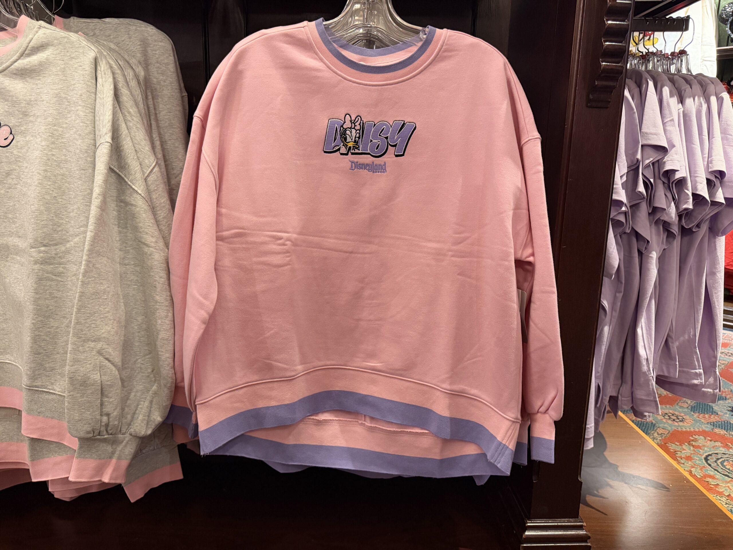 This pullover is in the same style as the one above, but features Daisy. The shirt is pink but with a purple stripe on the hem.