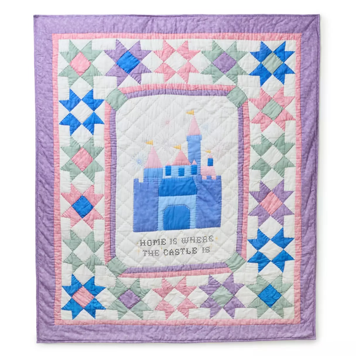 The 100% cotton blanket is 50" x 60." A blue and pink castle is in the center with "Home is where the castle is." It's surrounded by pink, purple, green, and blue quilting stars followed by pink and purple borders, all set against an ivory background.