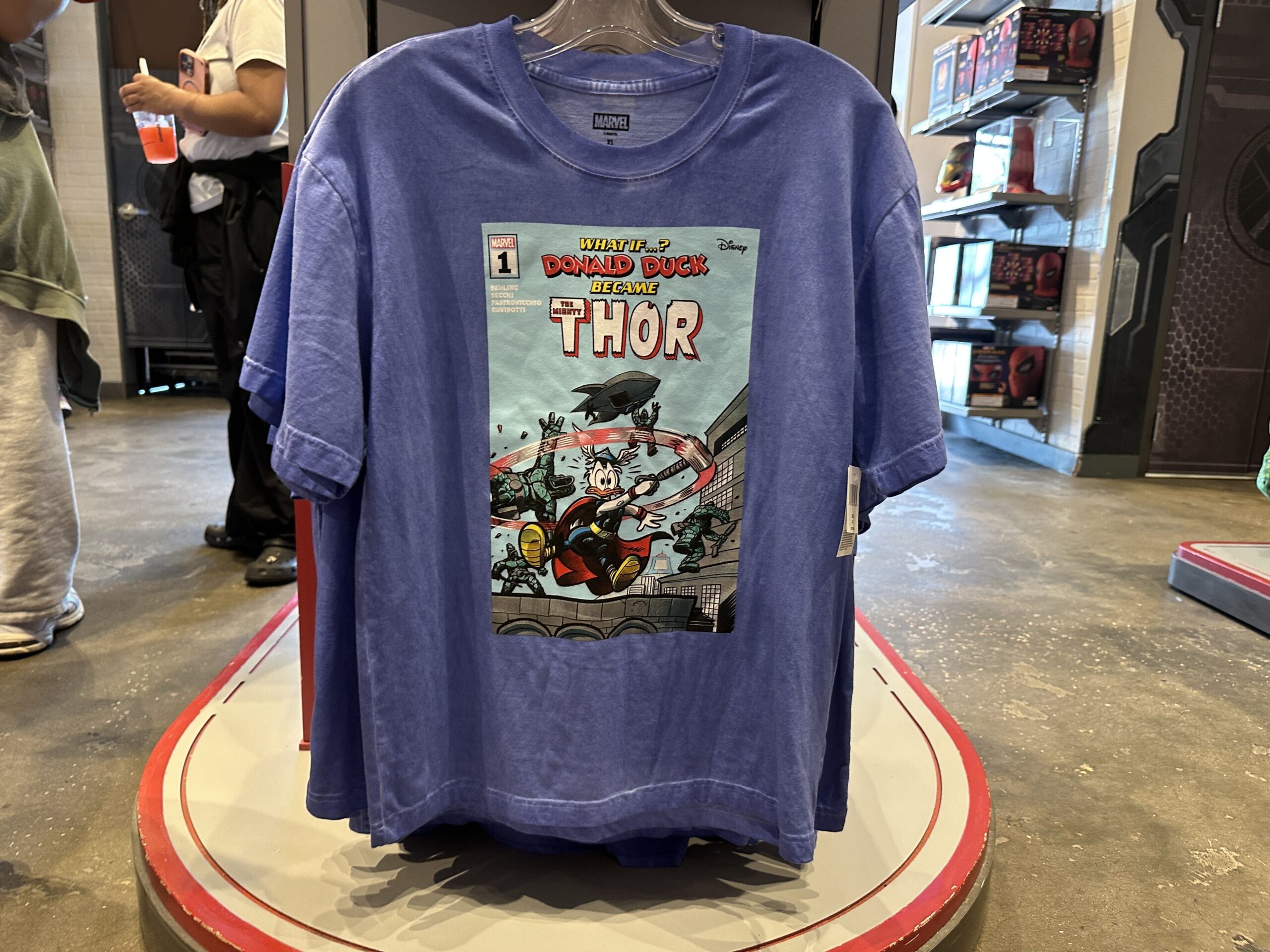 Another "What if...?" t-shirt, this time in a lavender color, shows Donald Duck as Thor. He is shown chaotically swinging his hammer (Mjölnir) around.