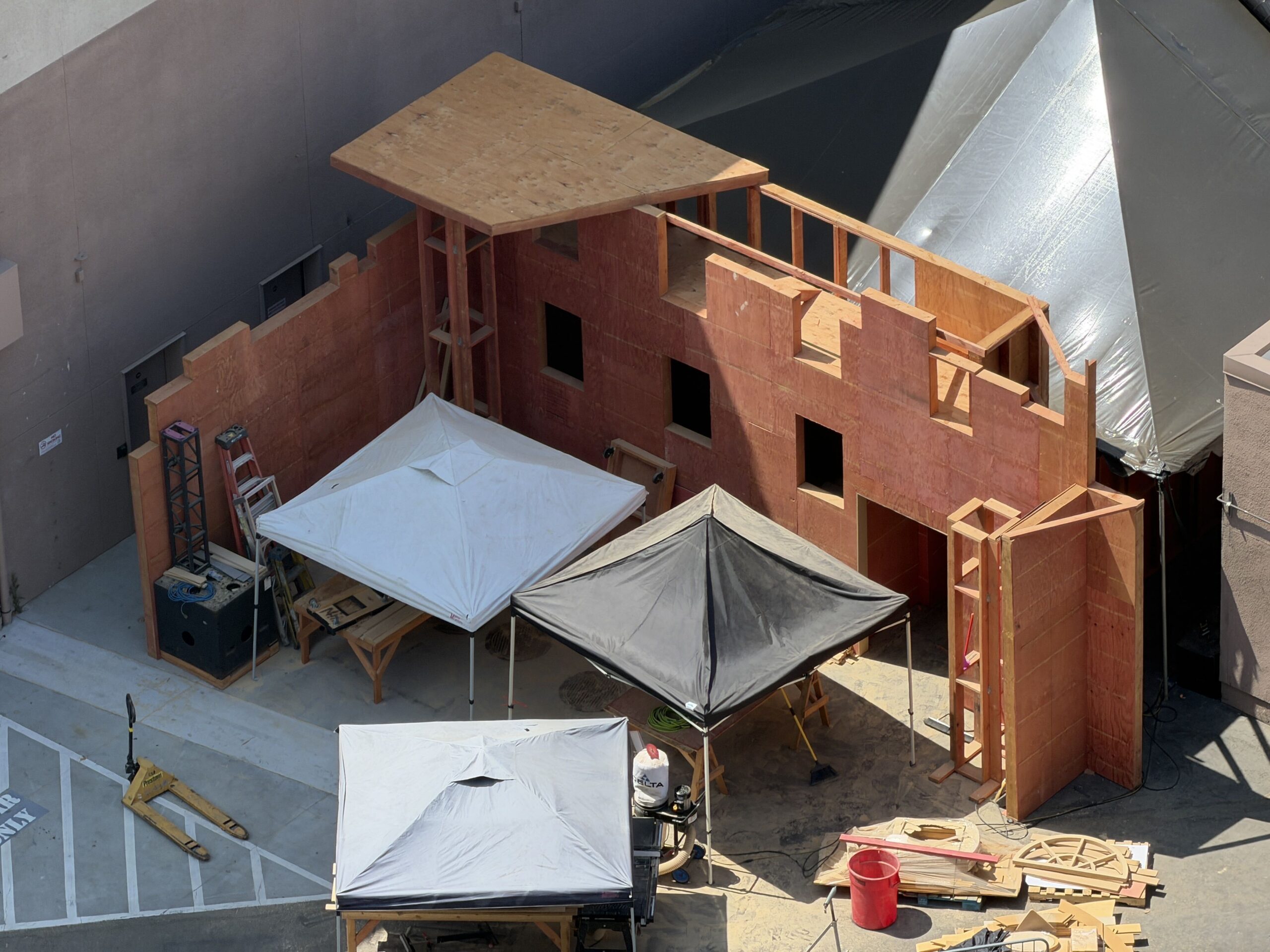 Then, over by where the Jurassic World - A Journey Through the Eras walkthrough attraction was for Universal Fan Fest Nights, we saw a ton of props, decor, and HHN storage. We even spotted the building of another haunted house. This one appears, thus far, to have a lot of windows being put in place.