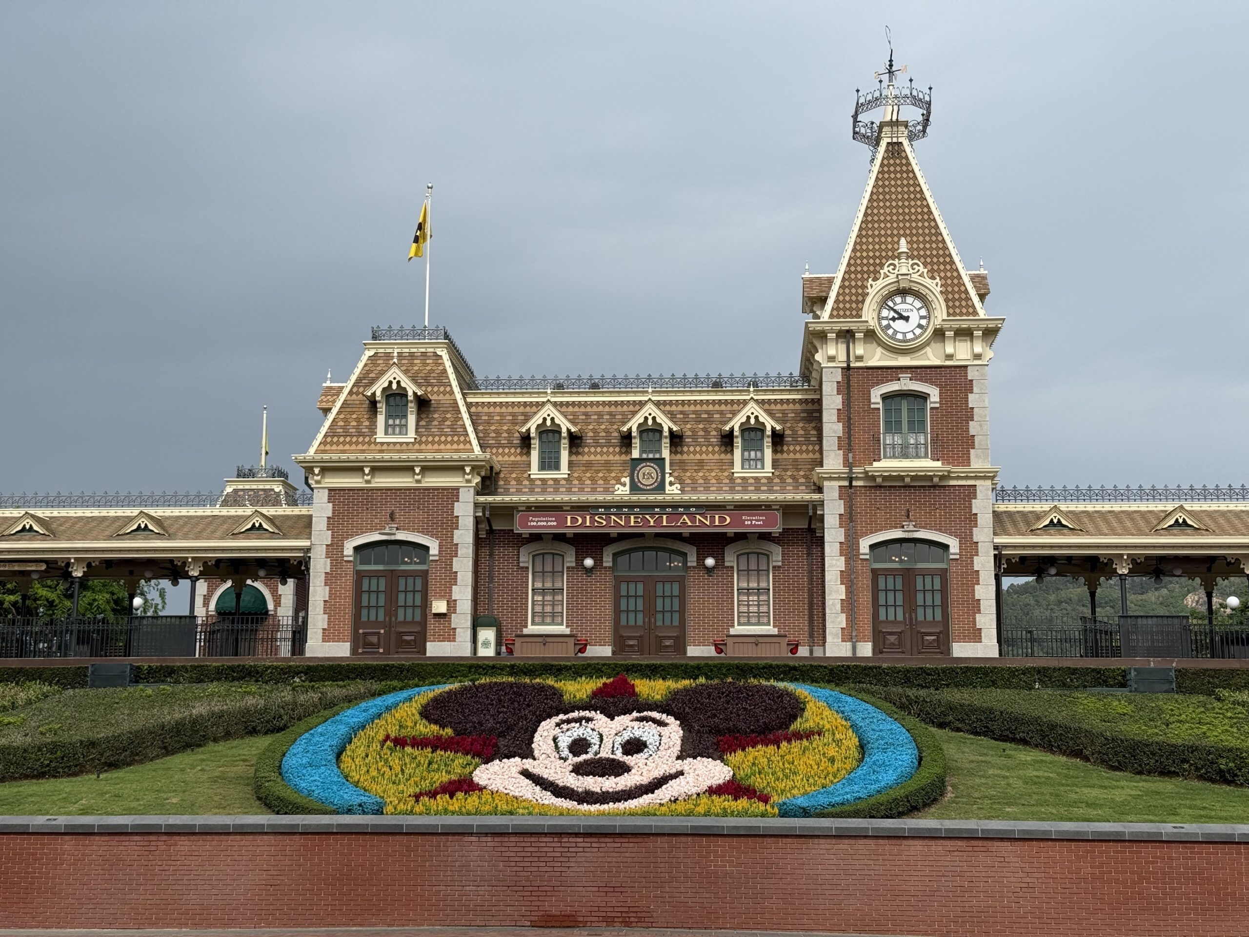 In front of the park, the Mickey flowerbed now sits against a Pixar ball-inspired background of red and yellow flowers and a blue hedge border.