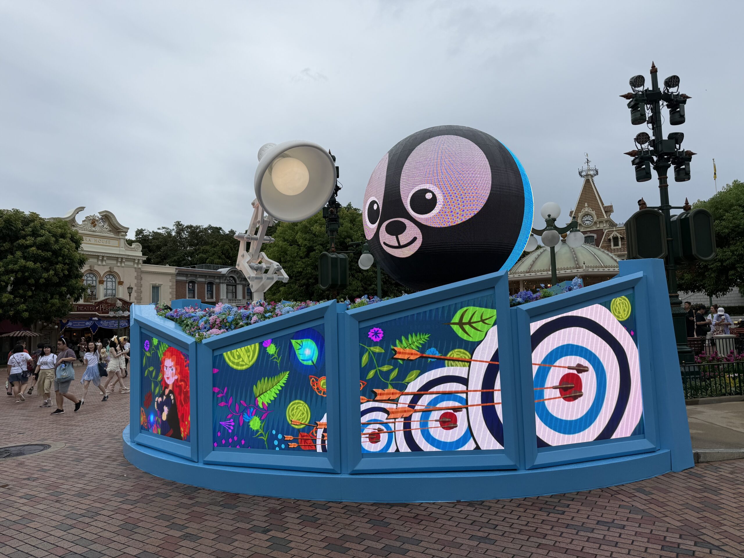 Sometimes, the ball transforms into one of Merida's bear brothers with the princess and archery targets on the walls below. Or you might see Miguel from Coco with papel picado on the walls.