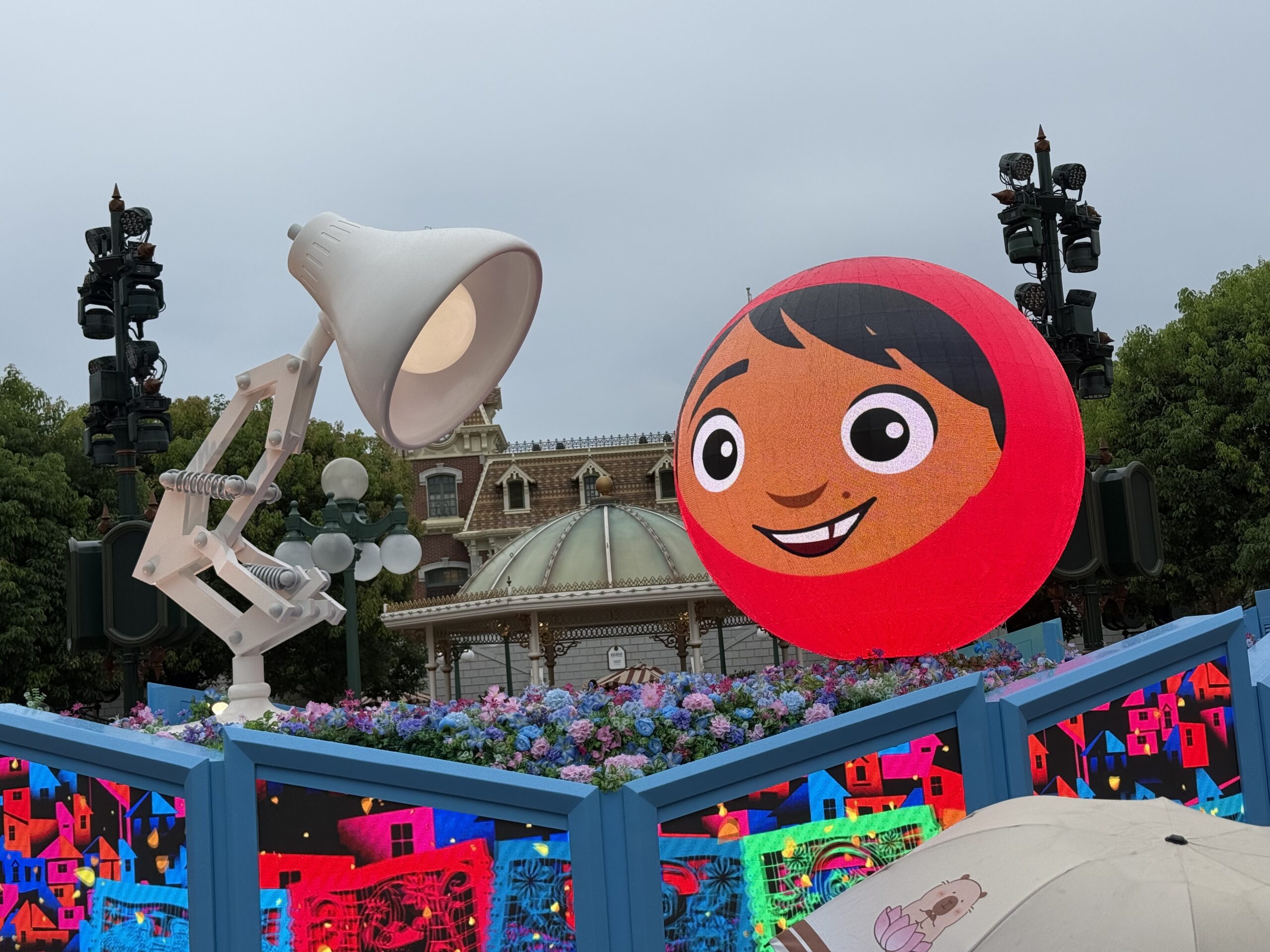 Sometimes, the ball transforms into one of Merida's bear brothers with the princess and archery targets on the walls below. Or you might see Miguel from Coco with papel picado on the walls.