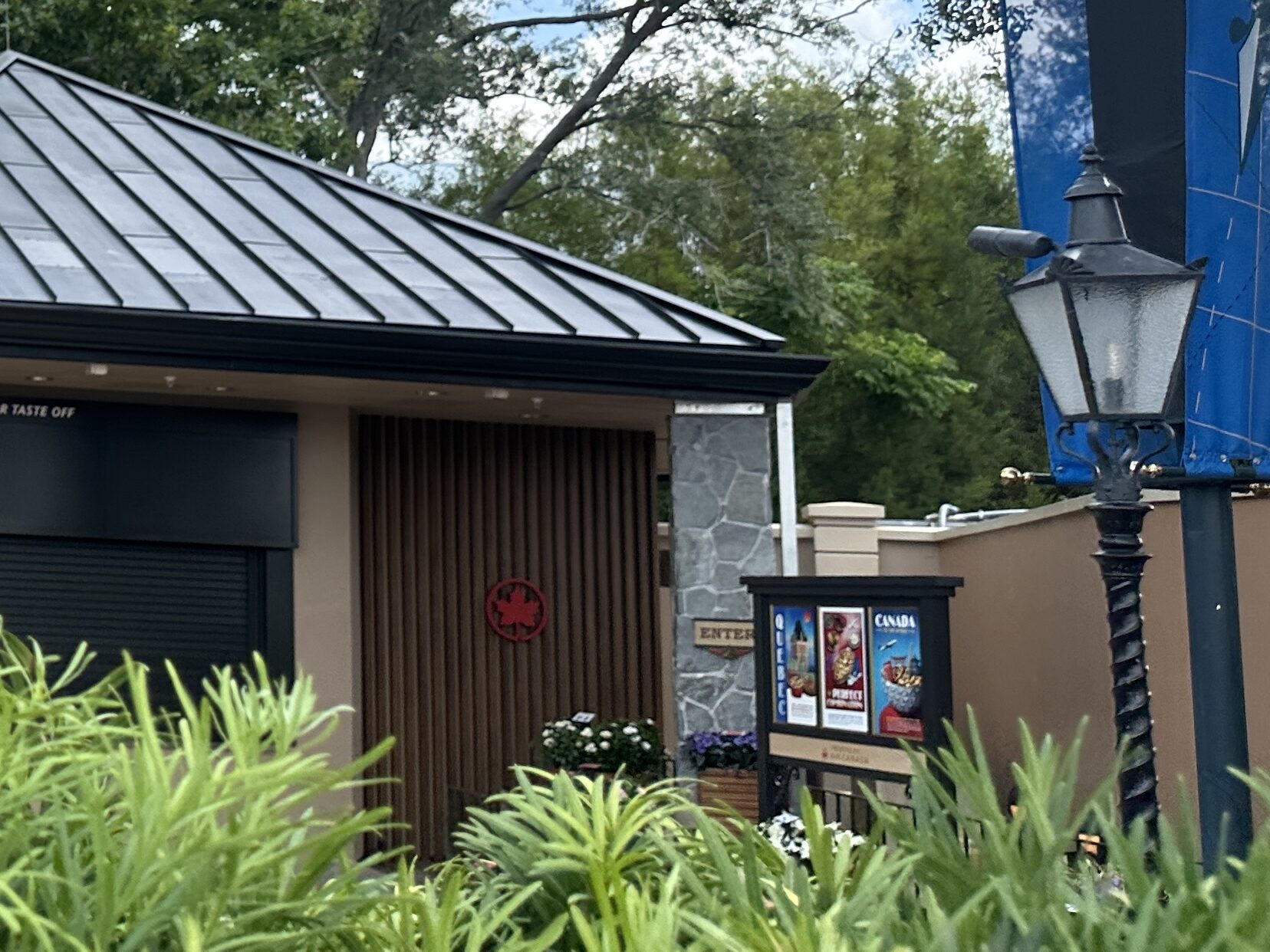 On the far right side of the eatery, near the decorative posters, we also saw a new "Enter" sign and some colorful flower boxes.