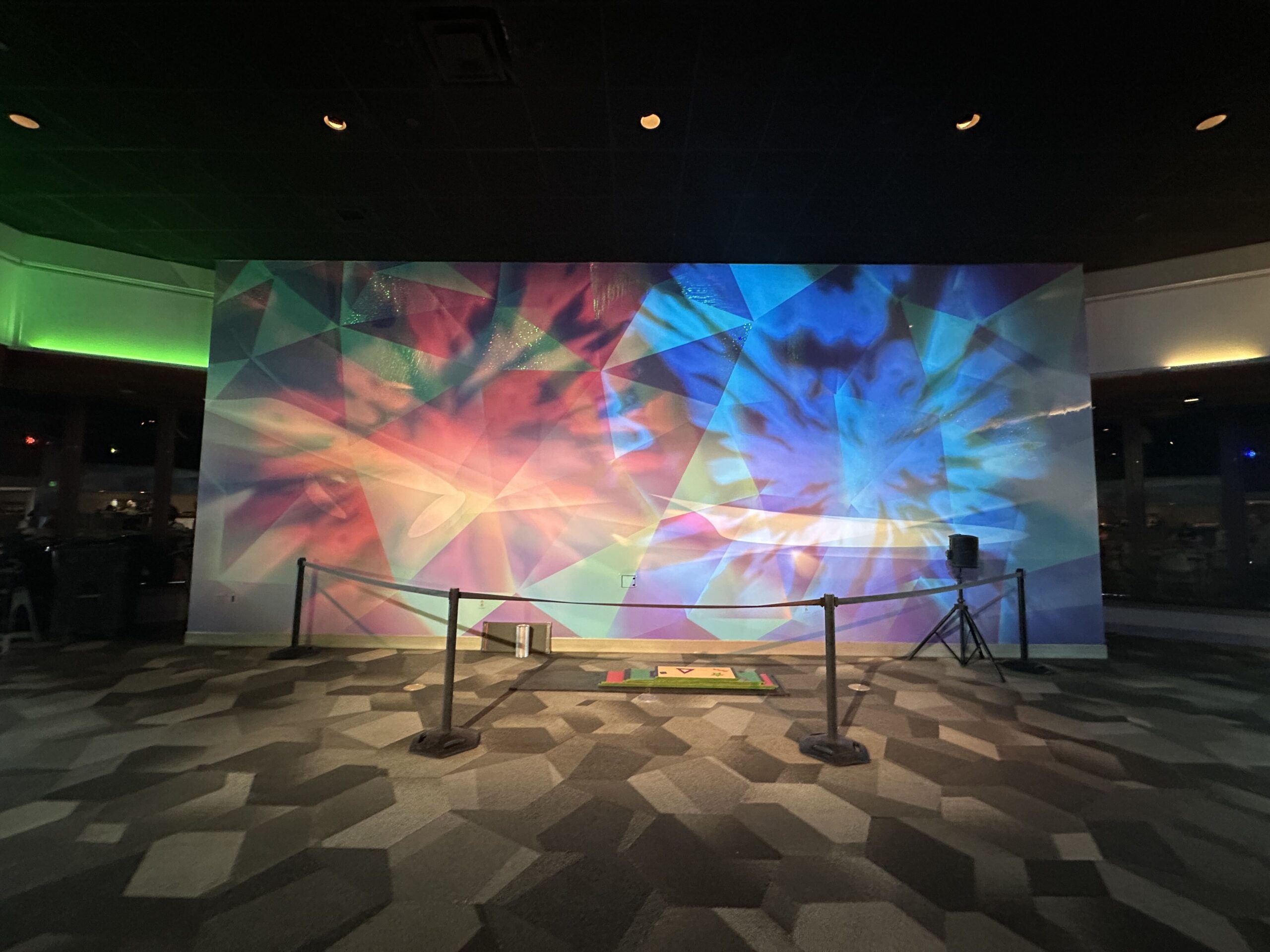 The decor theme of this lounge is clearly based on refraction, when light is split into a rainbow of colors when put through a prism. This refractive light quality is shown throughout the aptly named Light Lounge. Each area highlights various parts of the color spectrum. This area is primarily reds, greens, and blues.