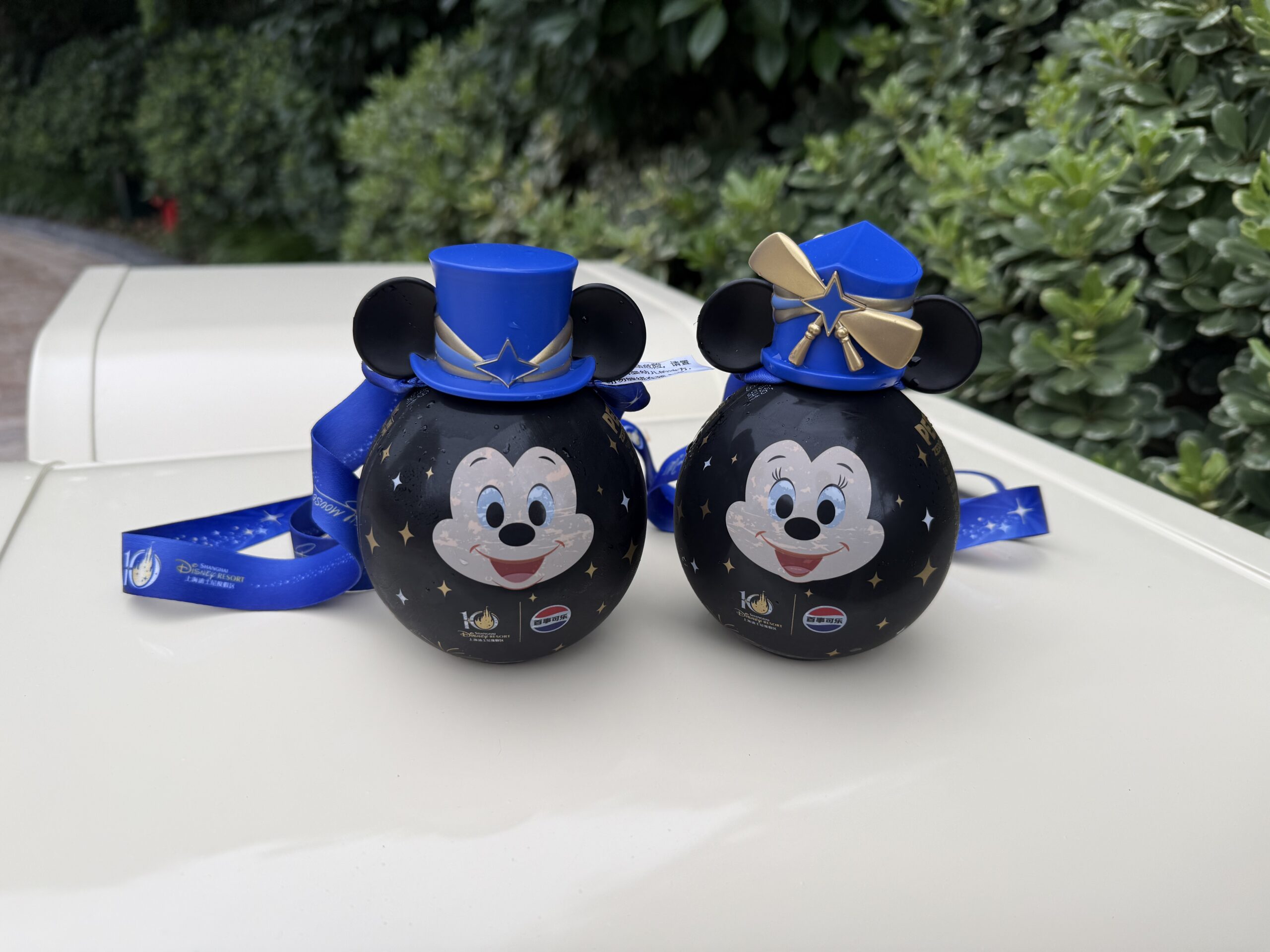These bottles, similar to the thermal detonator bottles at Star Wars: Galaxy's Edge, are filled with Pepsi Zero Sugar and have Minnie or Mickey's faces on them. Each has a Shanghai Disney Resort 10th anniversary hat on. These hats are made of hard plastic.