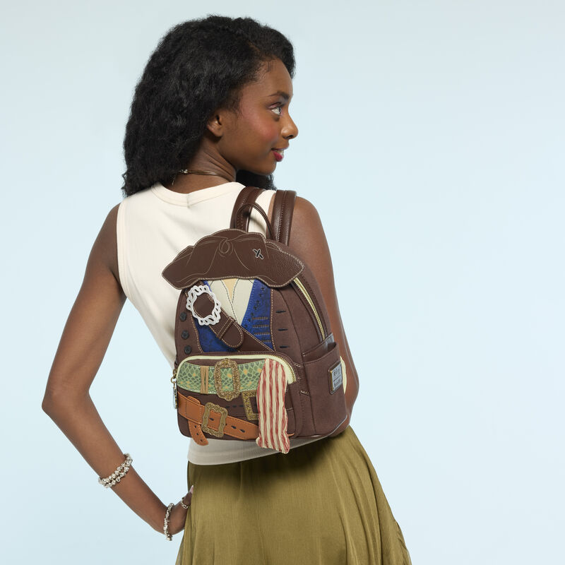 Inspired by Jack's costume, the bag is mostly a textured brown fabric with a tricorn hat appliqué on the front. A brown buckled strap crosses the front over blue and white shirt pieces. This is framed by real buttons and embroidered "holes."