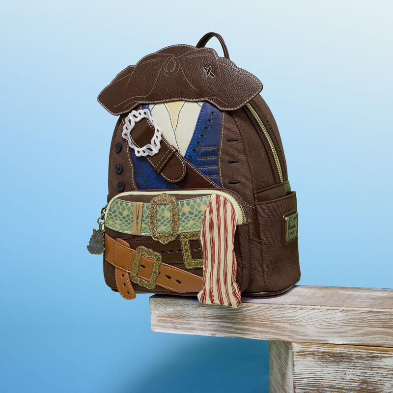 Inspired by Jack's costume, the bag is mostly a textured brown fabric with a tricorn hat appliqué on the front. A brown buckled strap crosses the front over blue and white shirt pieces. This is framed by real buttons and embroidered "holes."