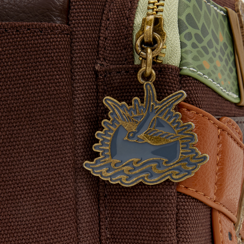 Inspired by Jack's costume, the bag is mostly a textured brown fabric with a tricorn hat appliqué on the front. A brown buckled strap crosses the front over blue and white shirt pieces. This is framed by real buttons and embroidered "holes."