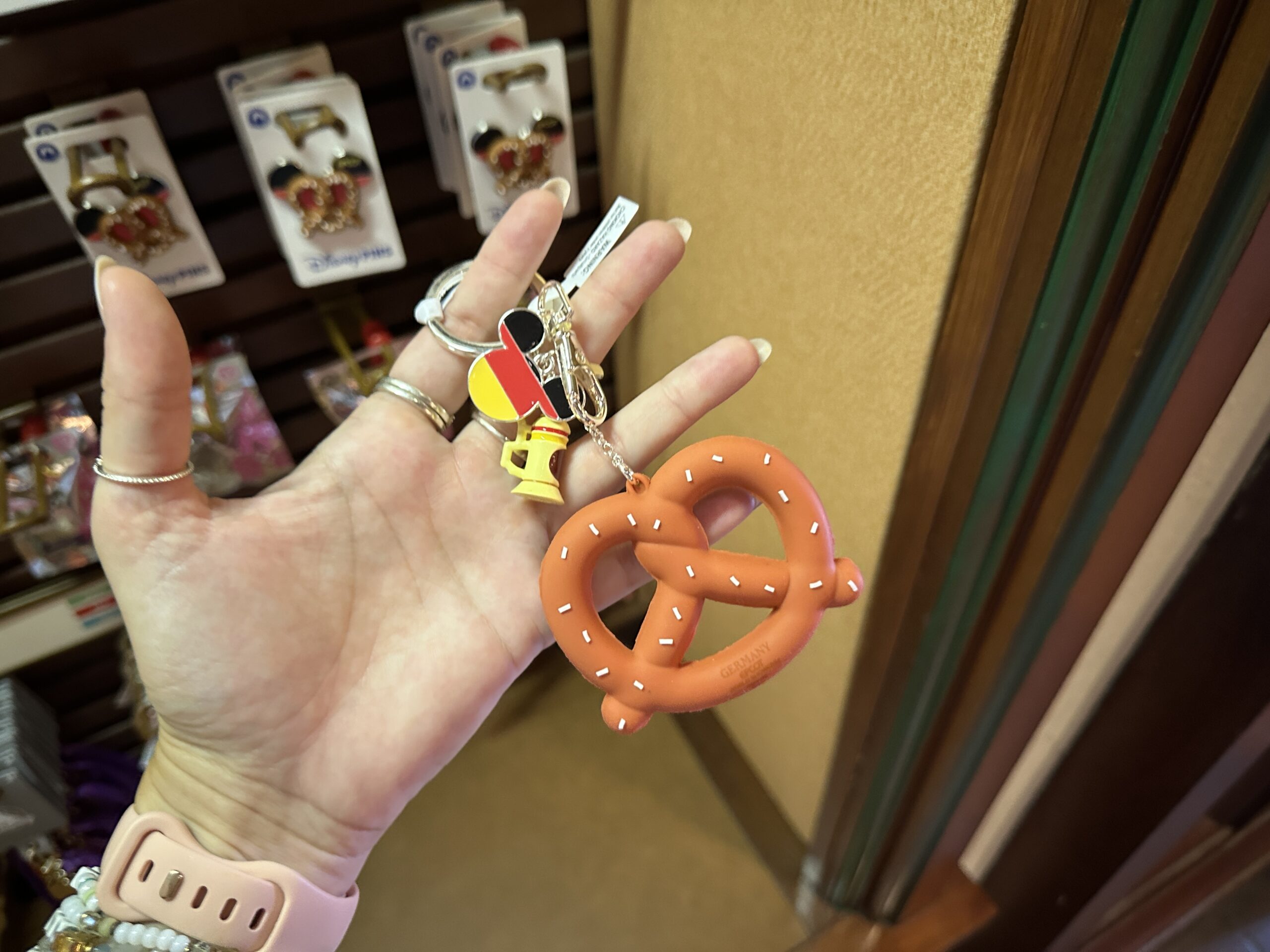 This keychain has three charms on it: an oversized salted pretzel, a beer stein, and a Mickey icon with the German flag colors inside it.