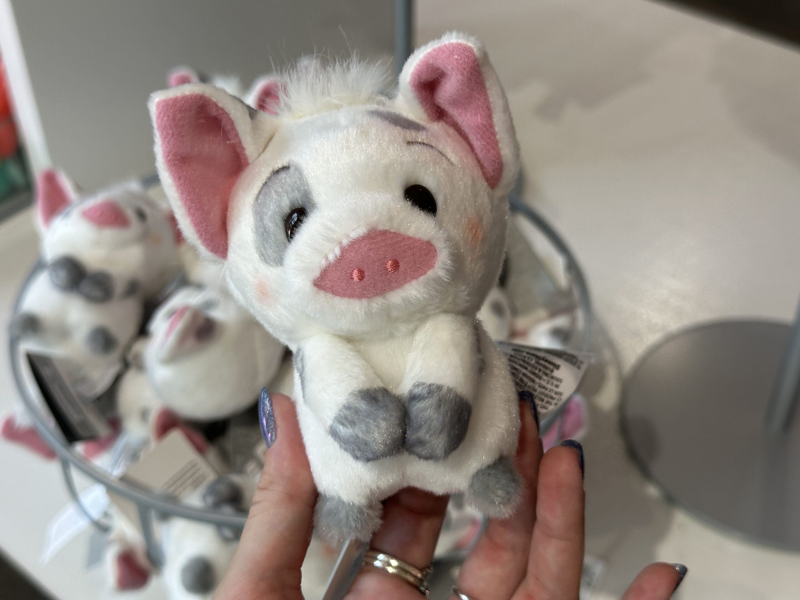 Pua's Urupocha-Chan plush shows the pig with his two front legs directly in front of his body. He has a slight blush to his cheeks and a little tuft of white hair sticking off of the top of his head.