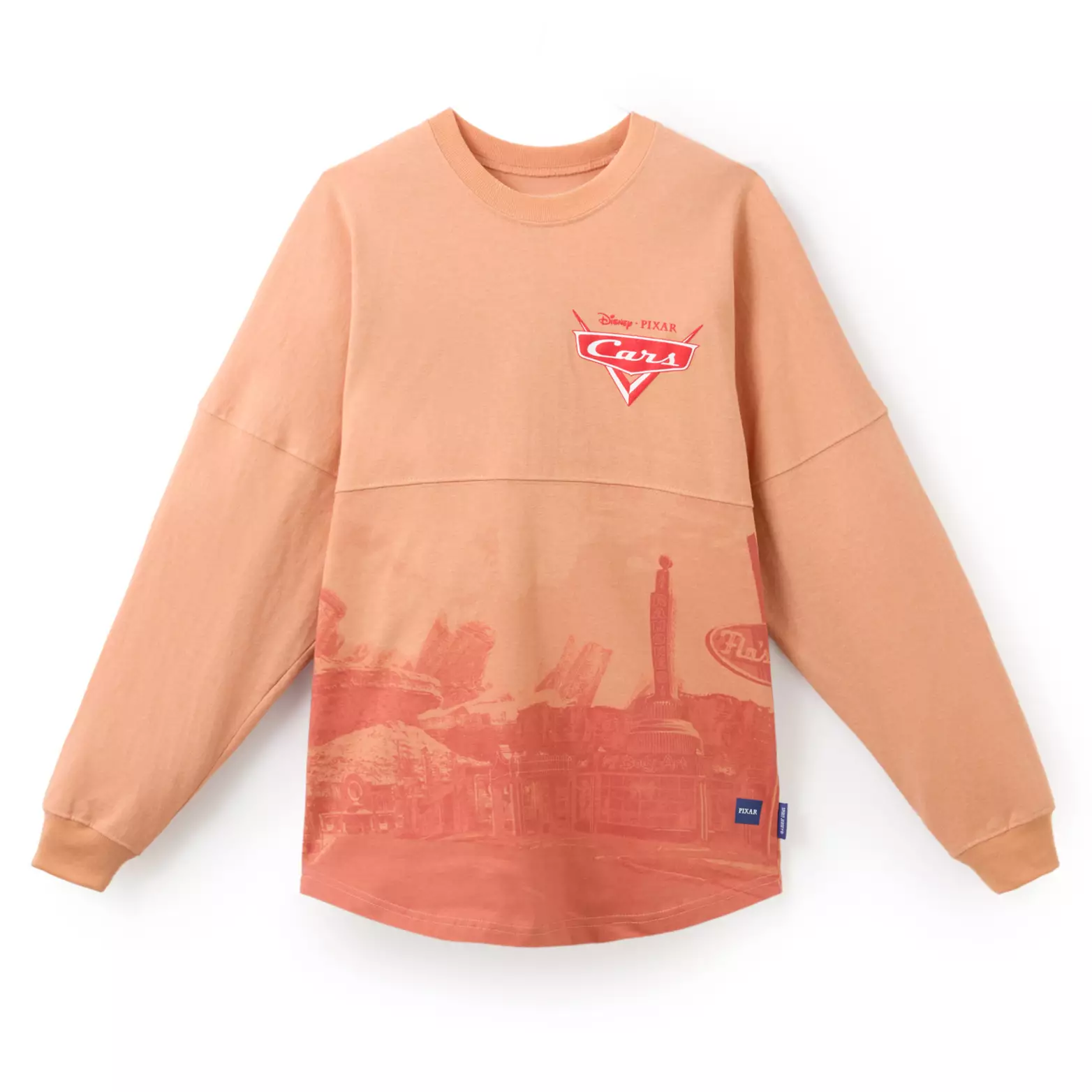 Dieses hellbraune Spirit-Trikot zeigt unten Radiator Springs und auf der Brust das Cars-Logo in Rot.