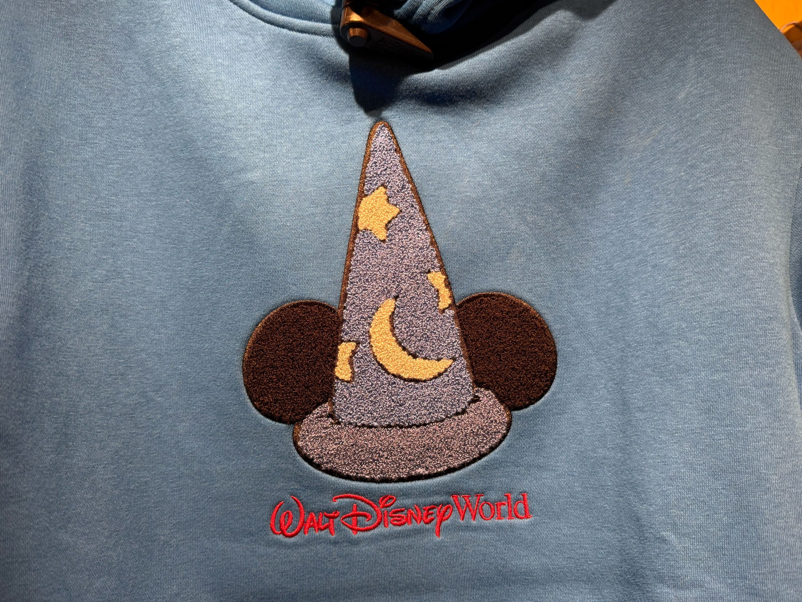 The Sorcerer Mickey hat has fuzzy detailing that shows the mouse ears as well as the crescent moon and white stars on the hat itself.