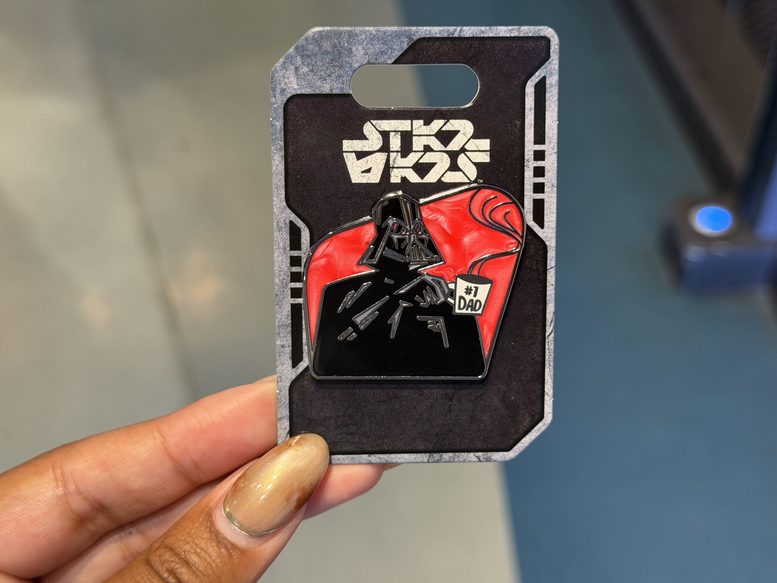 This Father's Day pin shows an annoyed-looking Darth Vader holding a mug that reads "#1 Dad." Steam is seen rising over the top of the mug.