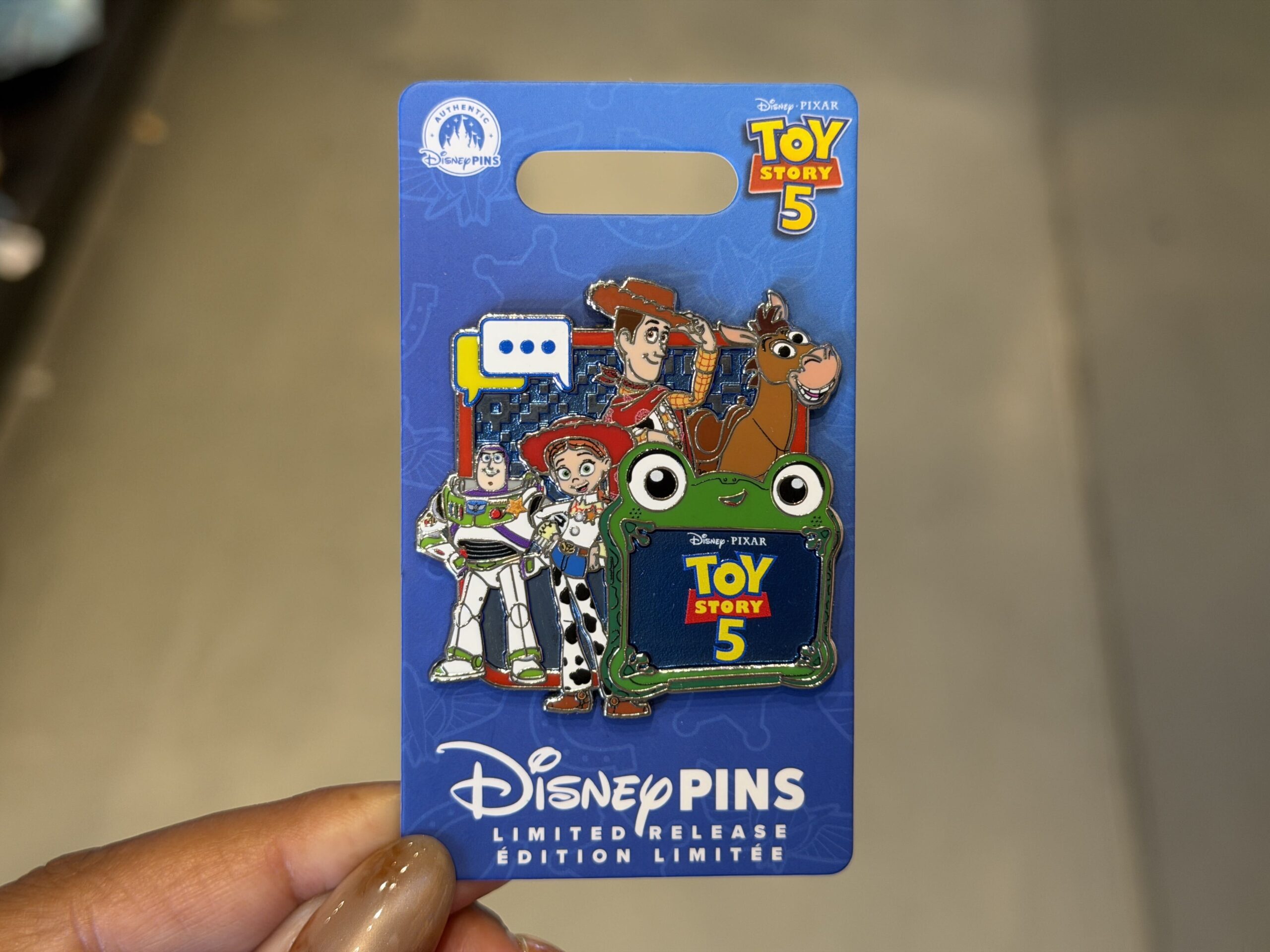 Woody, Jessie, Buzz, Bullseye, and Lilypad are on this pin against a techy background. The Toy Story 5 logo is on Lilypad's screen.