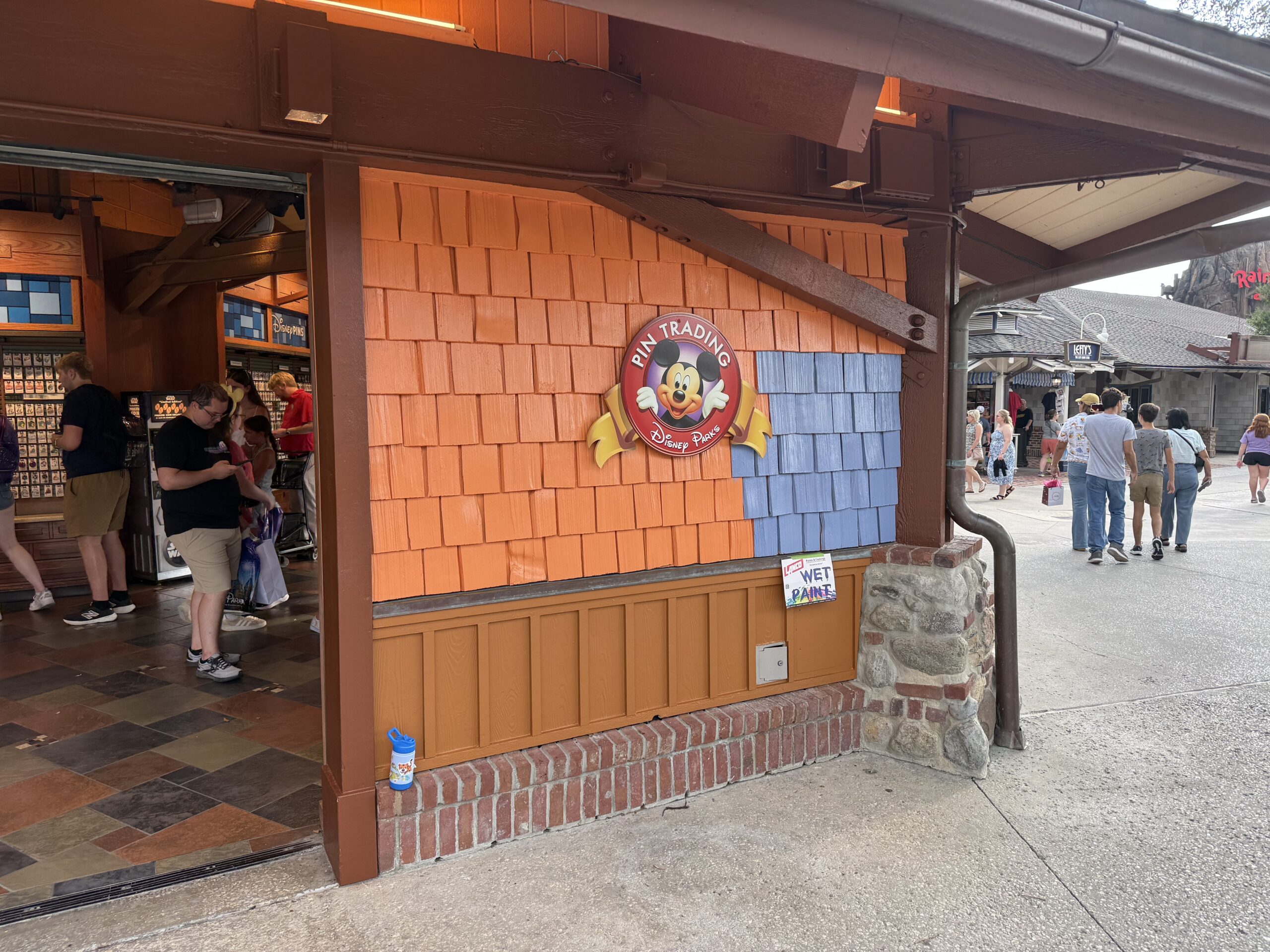 Pin Traders in Disney Springs is currently in the progress of being painted from an orange-brown to blue.
