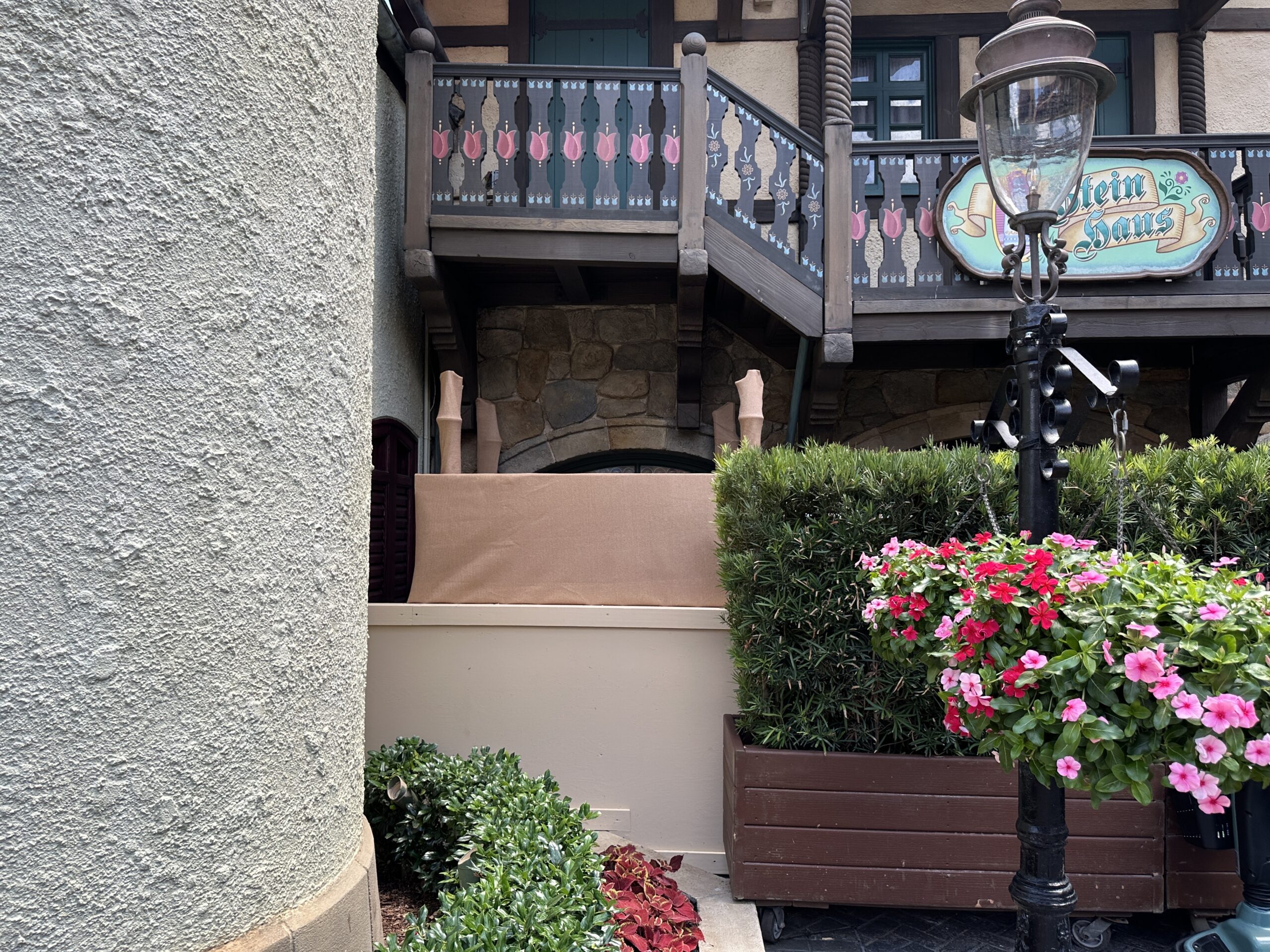 It looks like Disney is preparing for an exterior refurbishment of Stein Haus in the Germany Pavilion of EPCOT. Rolling planters, scrim, and scaffolding now block the shop's main entrance.