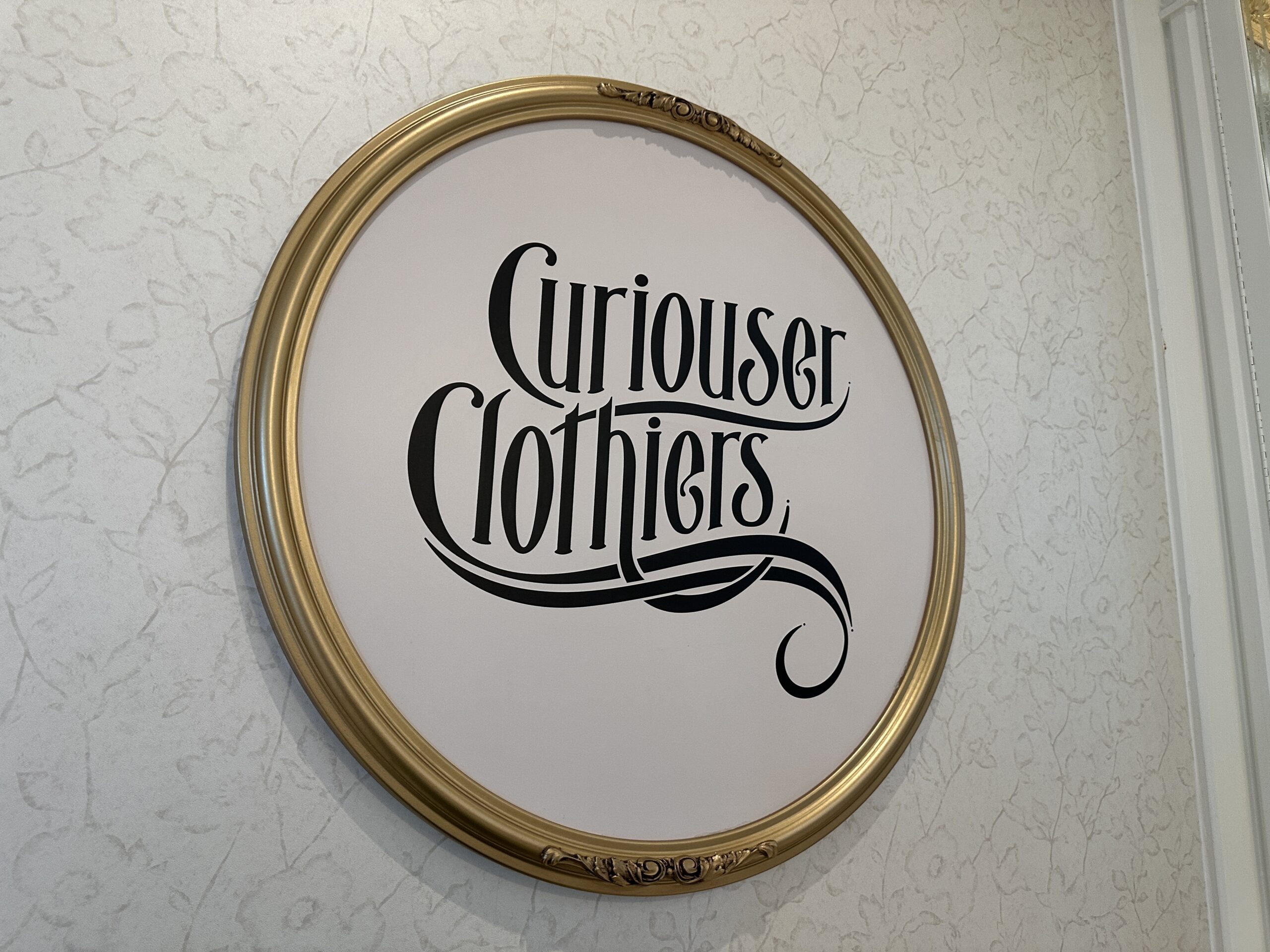 Curiouser Clothiers shop sign at Grand Floridian.