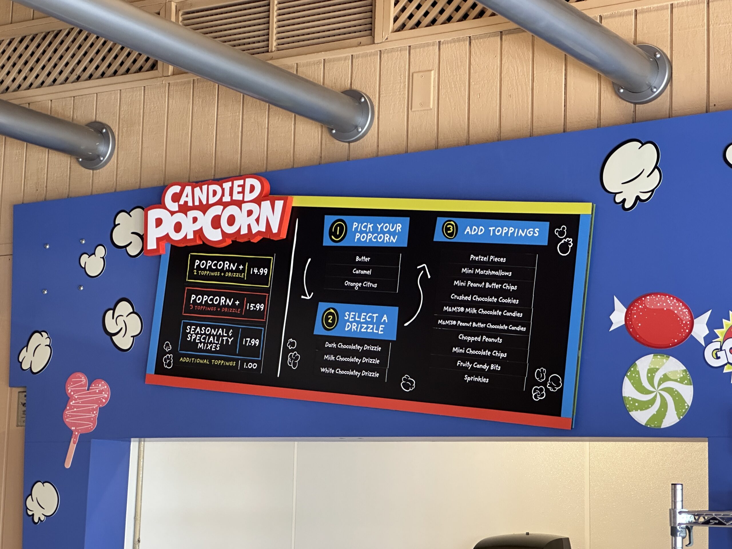 Similar to the popcorn options from the Kernel Kitchen in Main Street Confectionery at Magic Kingdom, guests can add all kinds of toppings to regular and flavored popcorn at Goofy's Candy Company.